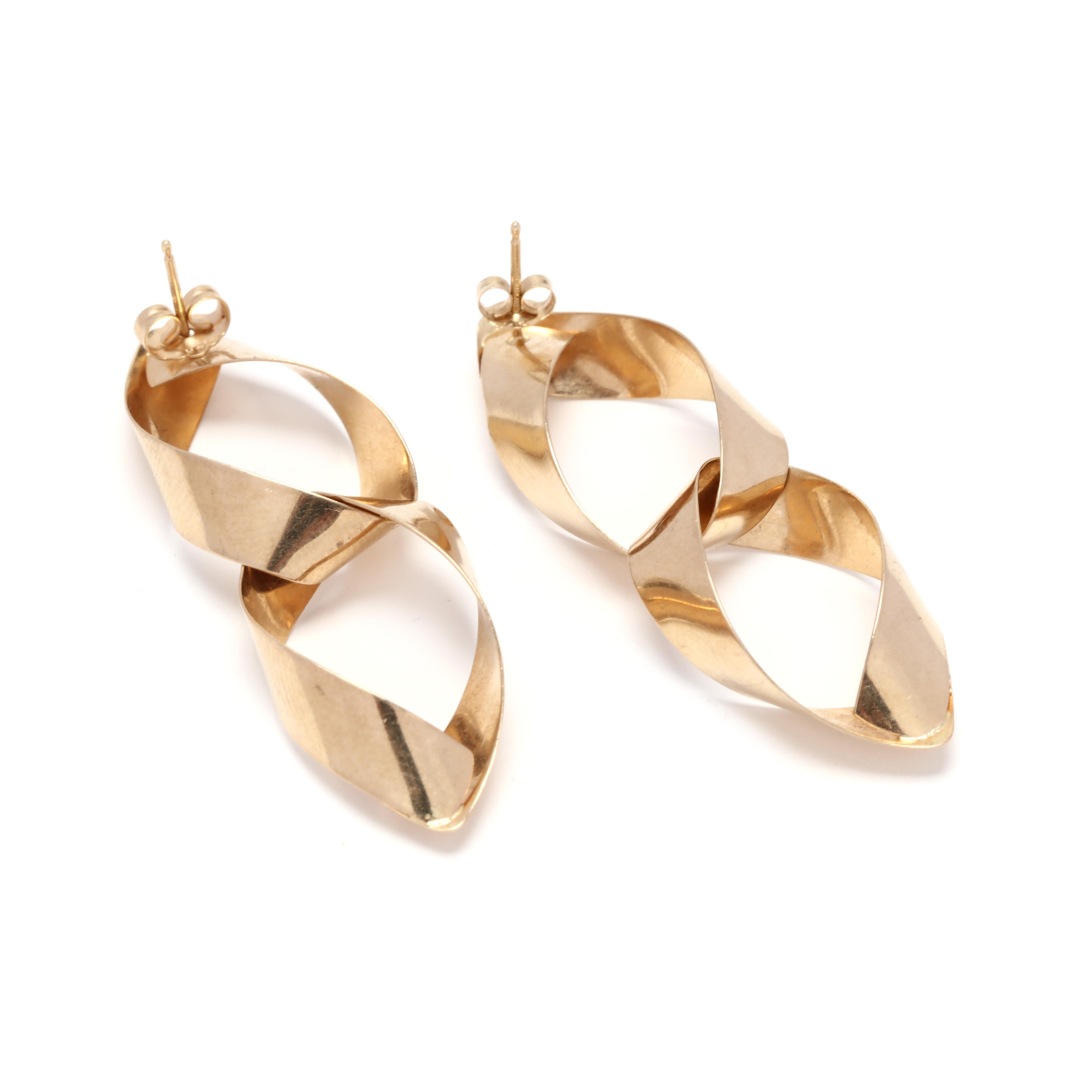 A pair of 14 karat yellow gold double pear shape ribbon dangle earrings. These earrings feature two flat pear shapes dangles with pierced post backs.

Length: 1.75 in.

Width: 5/8 in.

3.6 dwts.

A Couple Of Things to Note:
* This is a vintage item