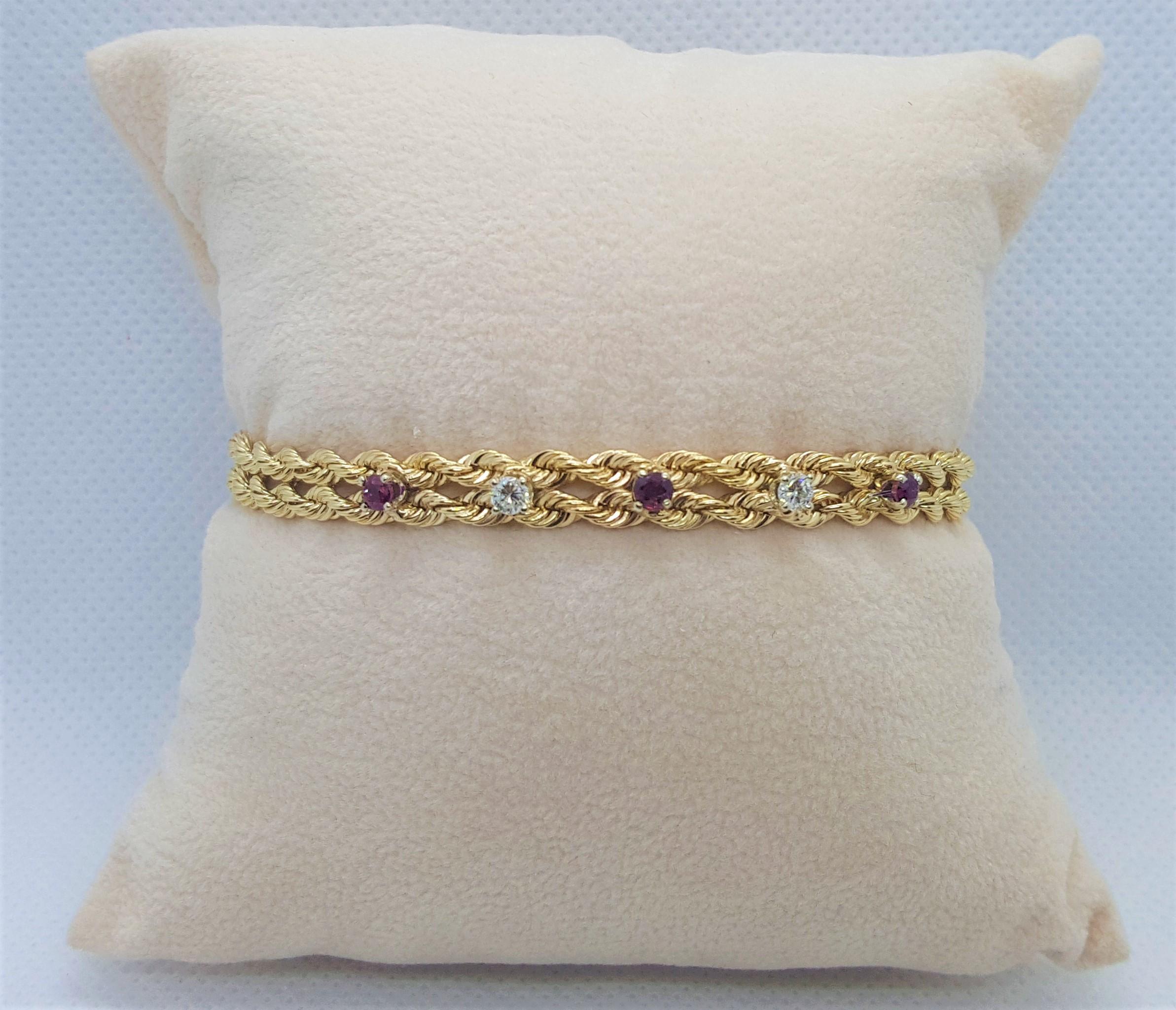 14kt yellow gold double rope bracelet with 3 rubies of approximately .10cttw and 2 round brilliant diamonds of approximately .10cttw. The diamonds are G color and SI clarity and in well-proportioned; the rubies do have a very slight abrasion due to