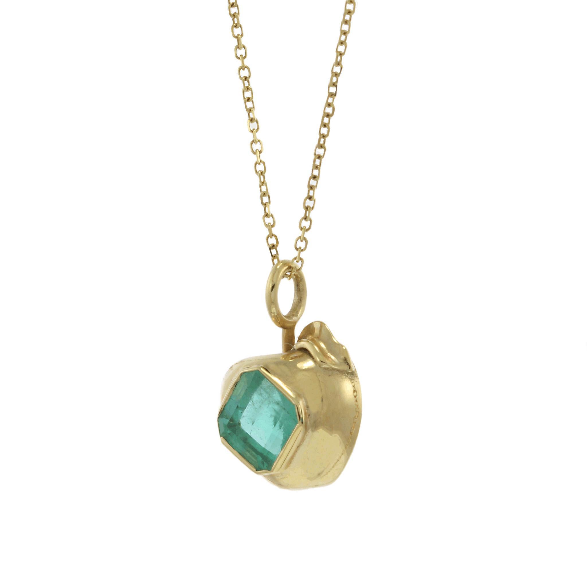 A charming estate apple-shaped pendant, crafted in 14KT yellow gold and set with a vibrant 0.80CT square-cut genuine emerald at its center. The rich green hue of the emerald beautifully contrasts with the warm gold setting, creating a playful yet