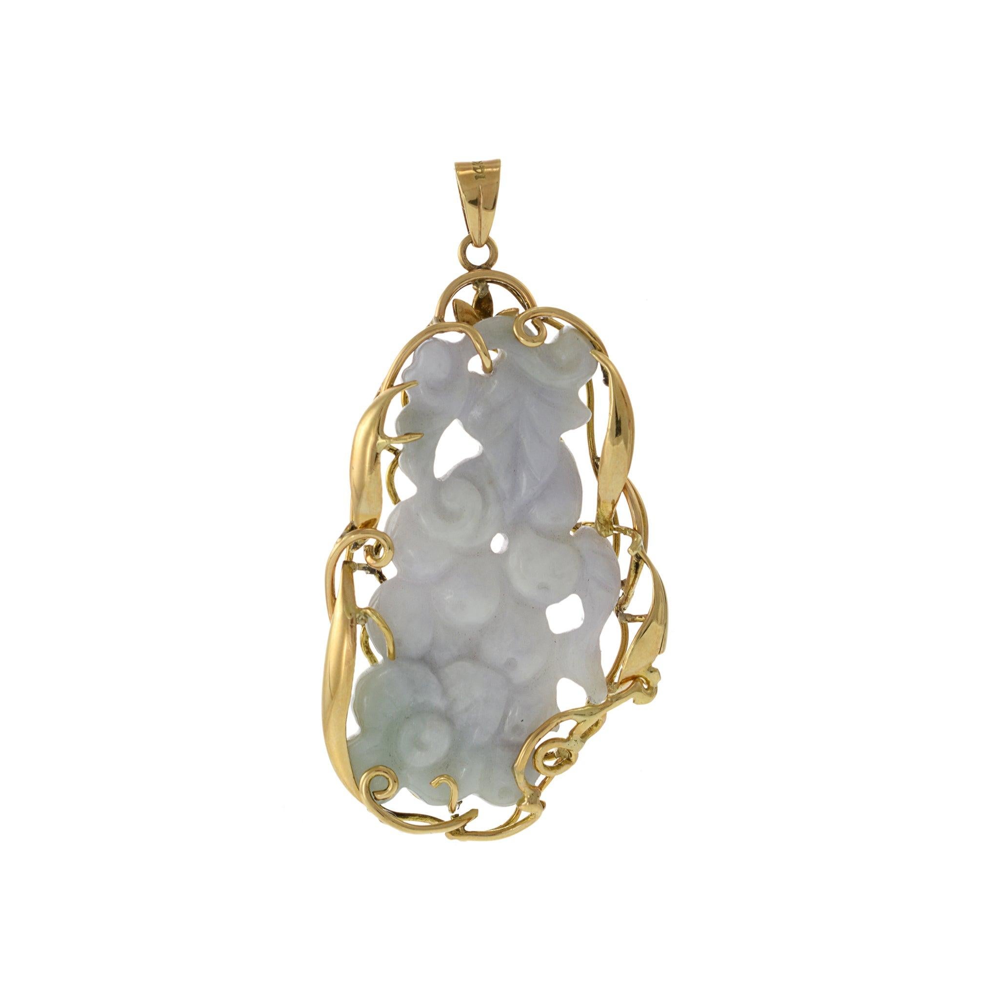 This exquisite estate pendant, weighing 19.11 grams, features a beautifully carved piece of genuine white and green jade, set in 14KT yellow gold. The intricate carving showcases the natural beauty and vibrant colors of the jade, making this pendant