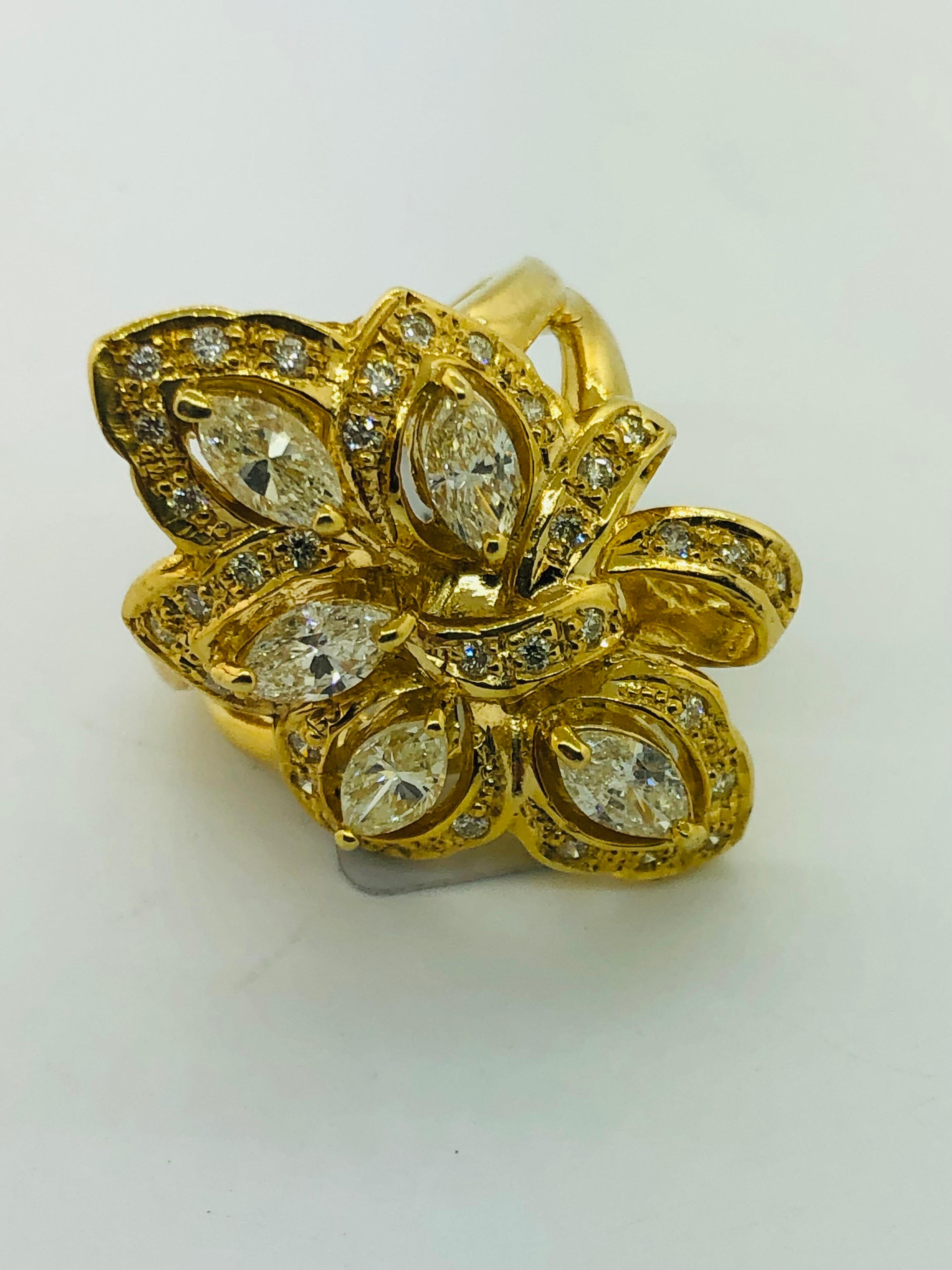 Showcasing a simply beautiful, elegant, and finely detailed vintage estate ring, featuring five center stone marquise diamonds securely hand set, weighing approx. 1.86 total carat weight with natural round white diamonds on the sides; approx. 0.44