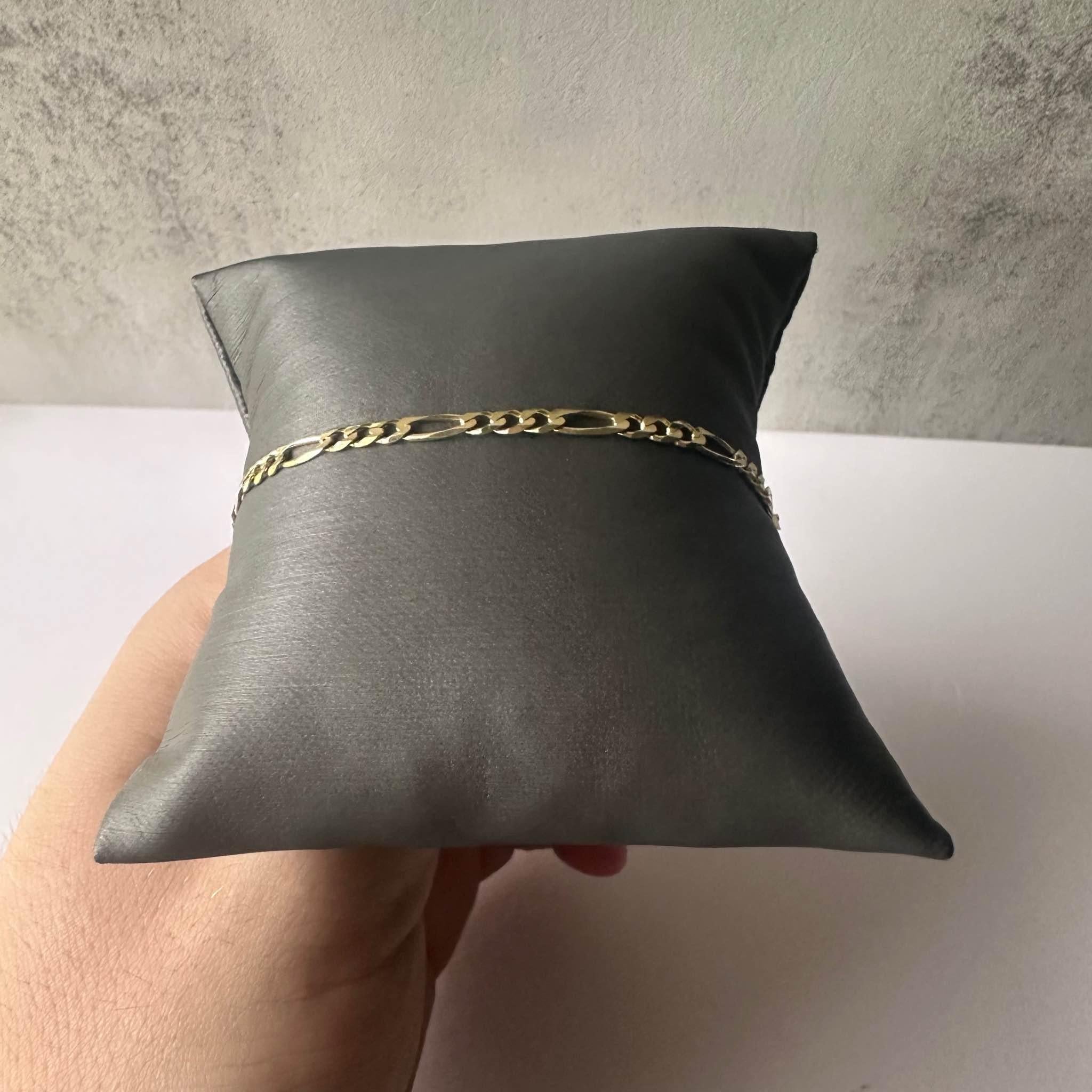 Elevate your style with this exquisite 14kt Gold Figaro Chain Bracelet. Crafted from luxurious yellow gold, this bracelet features a classic Figaro link design, offering a timeless and sophisticated look.

Craftsmanship and Quality: This elegant