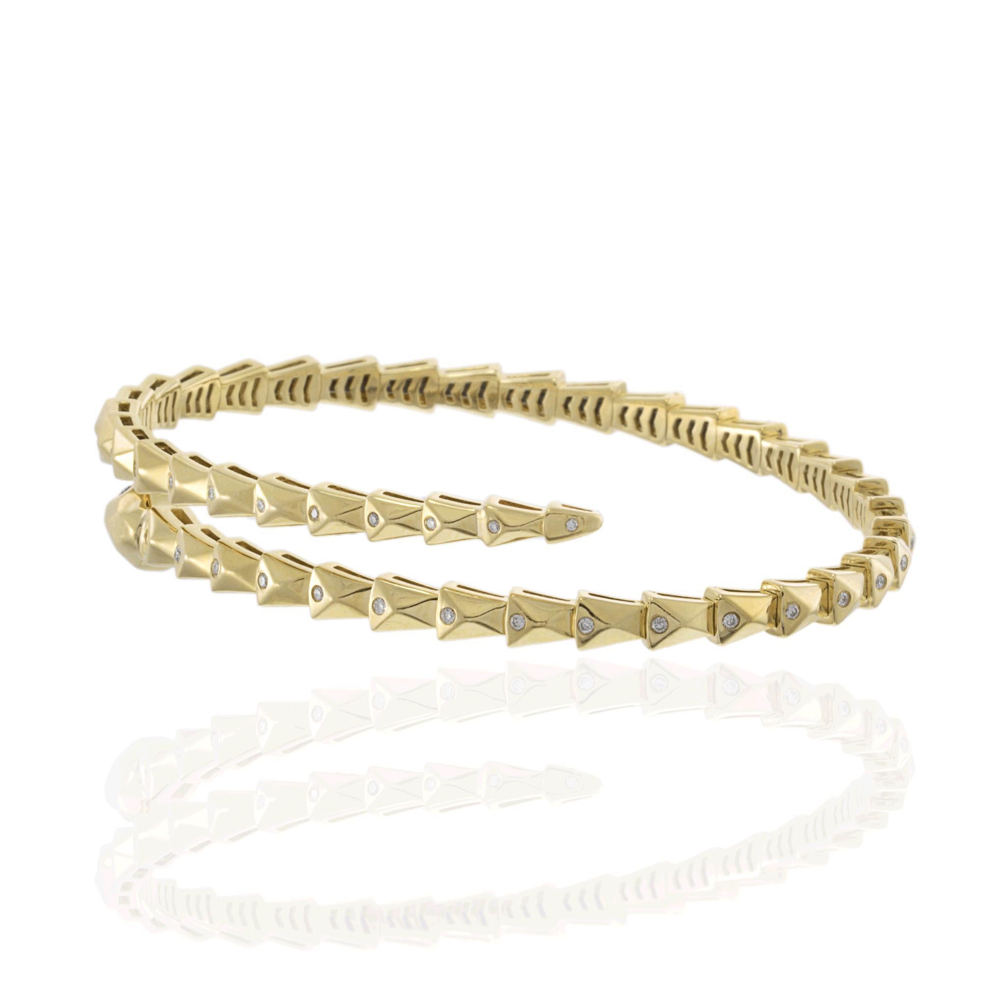 A striking and elegant snake-inspired wrap bracelet, crafted in 14KT yellow gold with a flexible design for a comfortable fit. The bracelet coils gracefully around the wrist, embodying the timeless symbolism of strength and transformation. The