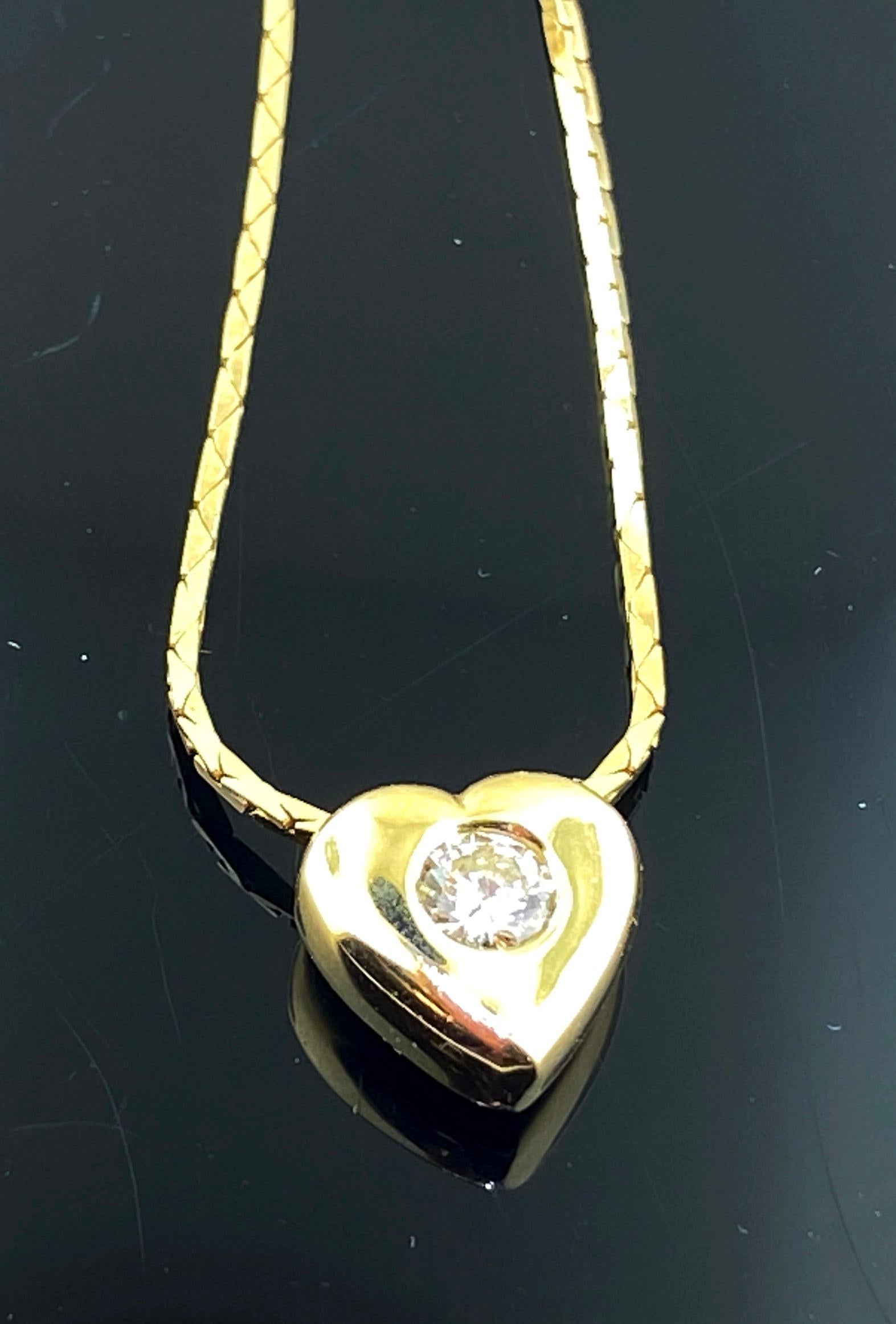 14 karat Yellow Gold Heart Pendant with an 0.33 carat Round Brilliant cut diamond on one side, Color Grade of G-H, Clarity of I-1, on the flip side is an 0.33 carat Round Brilliant Cut blue Sapphire.  The chain is also 14 karat yellow gold and is