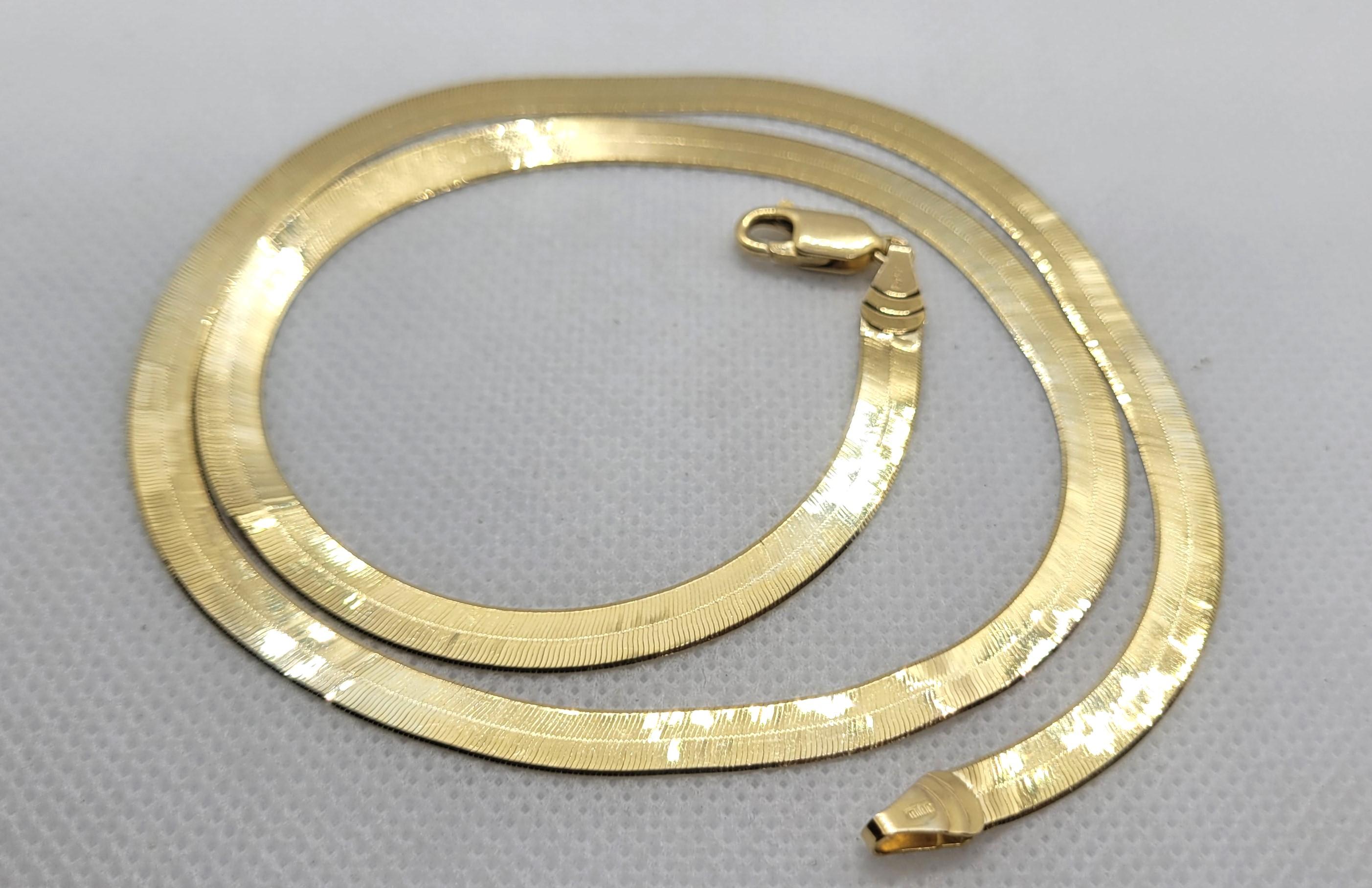 14kt Yellow Gold Herringbone Chain, 20 Inches, Italian Made, 5.2mm Wide, Milor. This Italian-made 14kt yellow gold herringbone chain is an exquisite piece of jewelry that exudes elegance and style. With its 20-inch length and 5.2mm width, it is the