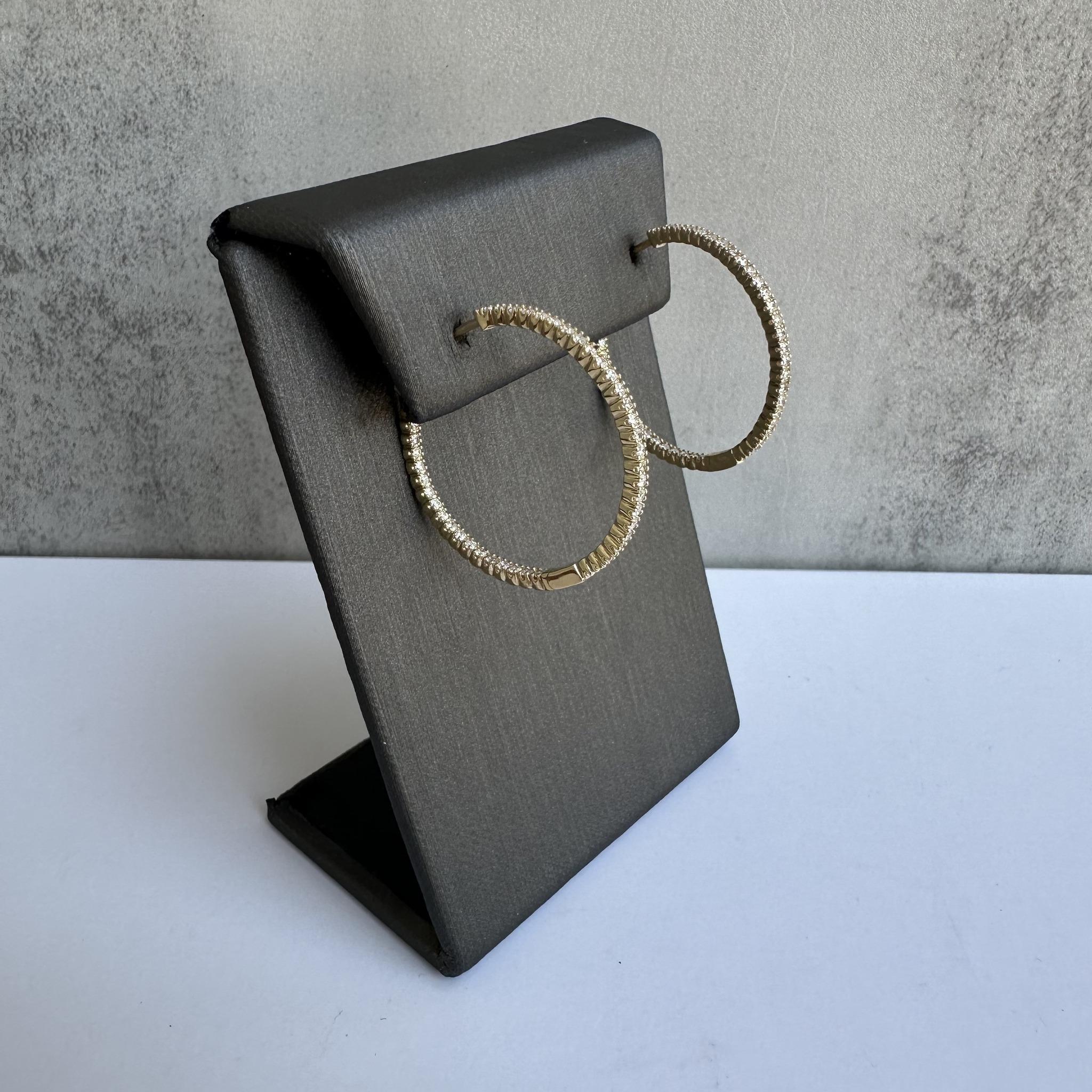 Add a touch of luxury to your jewelry collection with these 14kt Yellow Gold Inside/Outside Diamond Hoops. Featuring 1.10 carats of GH SI natural round diamonds, these hoops are designed to sparkle from every angle, with diamonds adorning both the