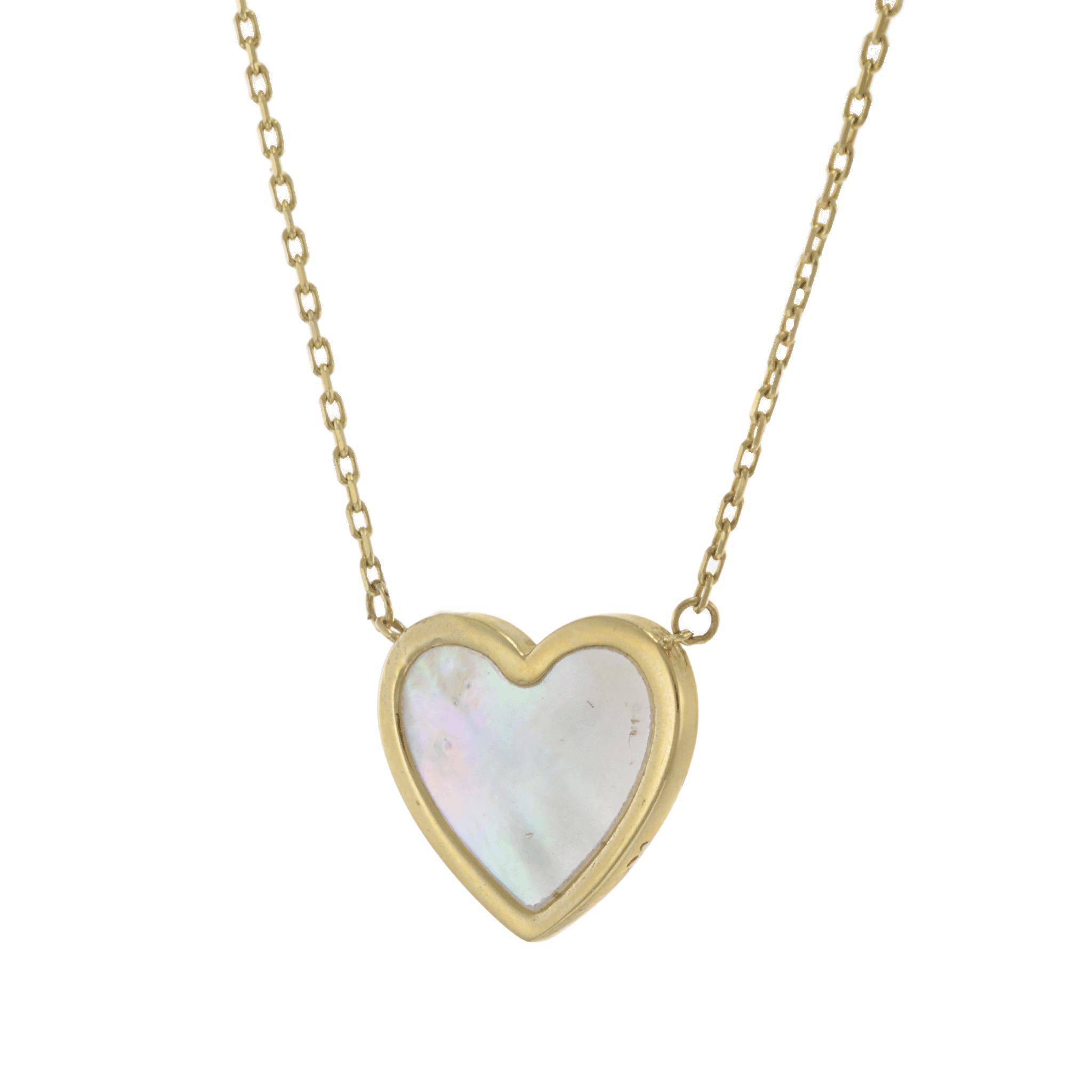 A beautifully crafted 14KT yellow gold heart pendant, featuring a smooth and luminous mother of pearl inlay that enhances its soft, iridescent glow. Suspended from a matching 14KT yellow gold chain, this pendant offers a classic and versatile design