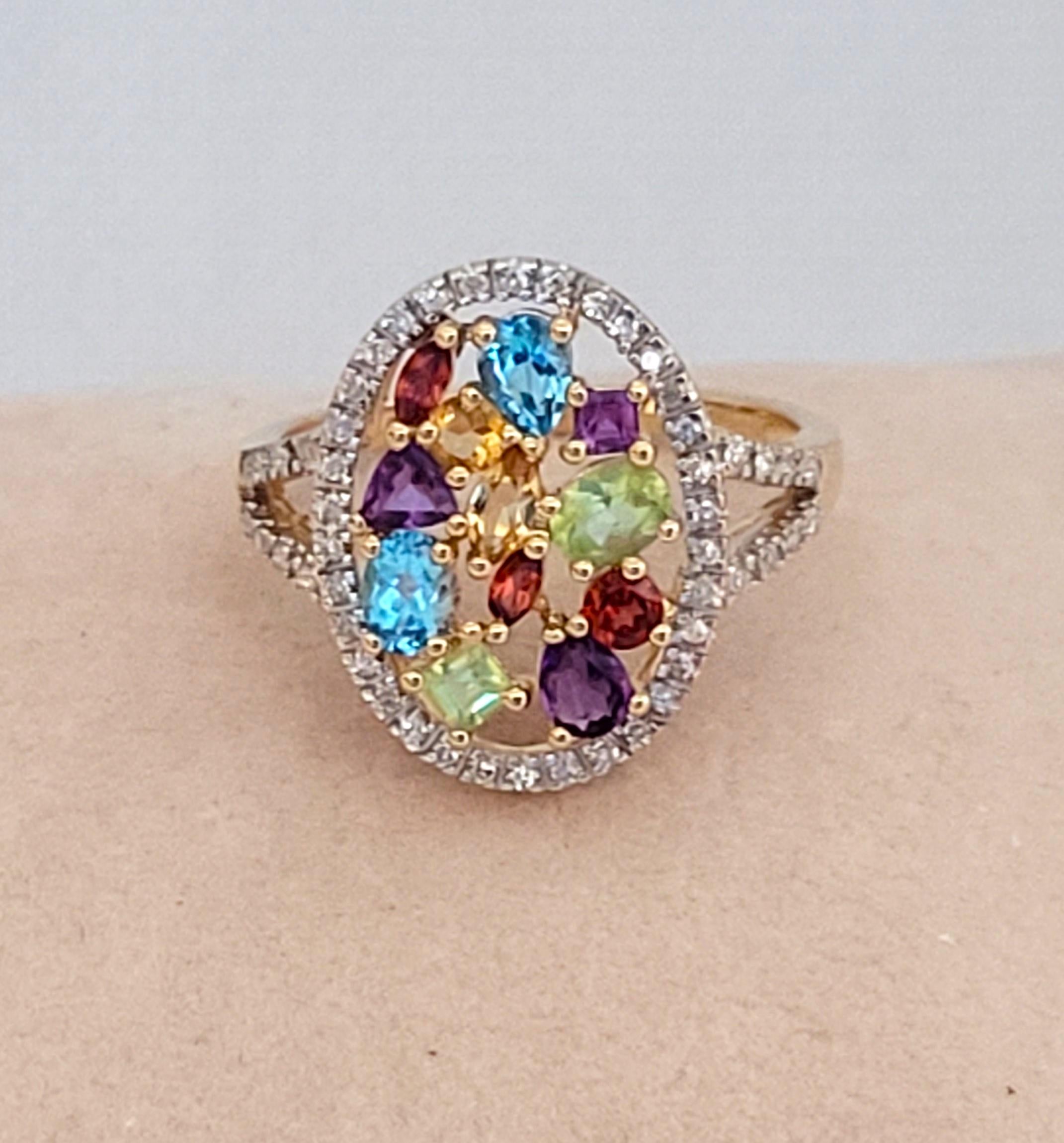 Beautiful 14kt yellow gold ring with round brilliant diamonds and multi-colored gemstones, topaz, citrine, peridot, garnet, and amethyst. The gemstone shapes are pear, marquis, trillion, round, princess cut, and oval. The round brilliant diamonds of