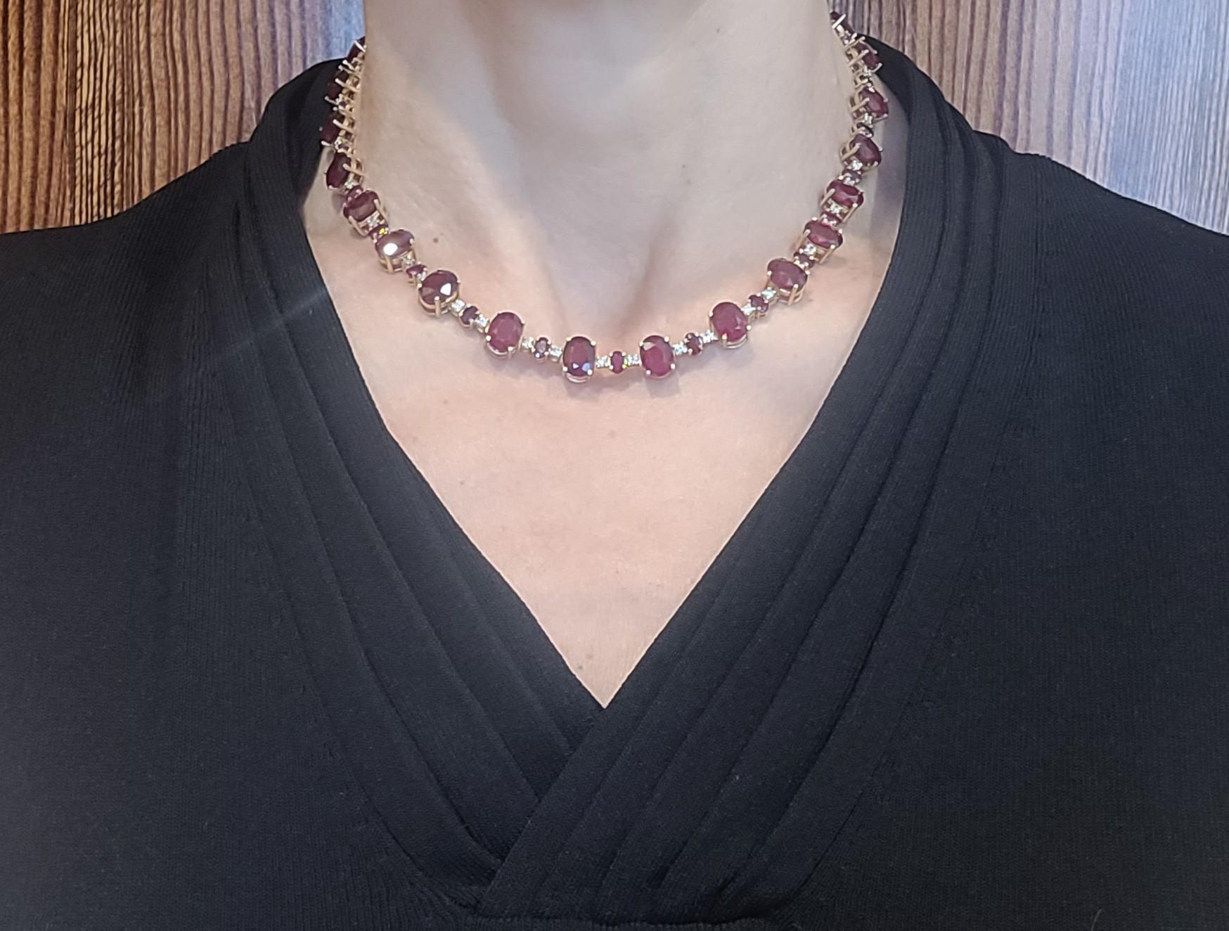 This necklace is made of 14kt yellow gold and features a total weight of 52.00 carats in rubies. It is adorned with 50 round brilliant diamonds, totaling 1.75 carats. The necklace also showcases 49 natural oval-shaped rubies, which have been