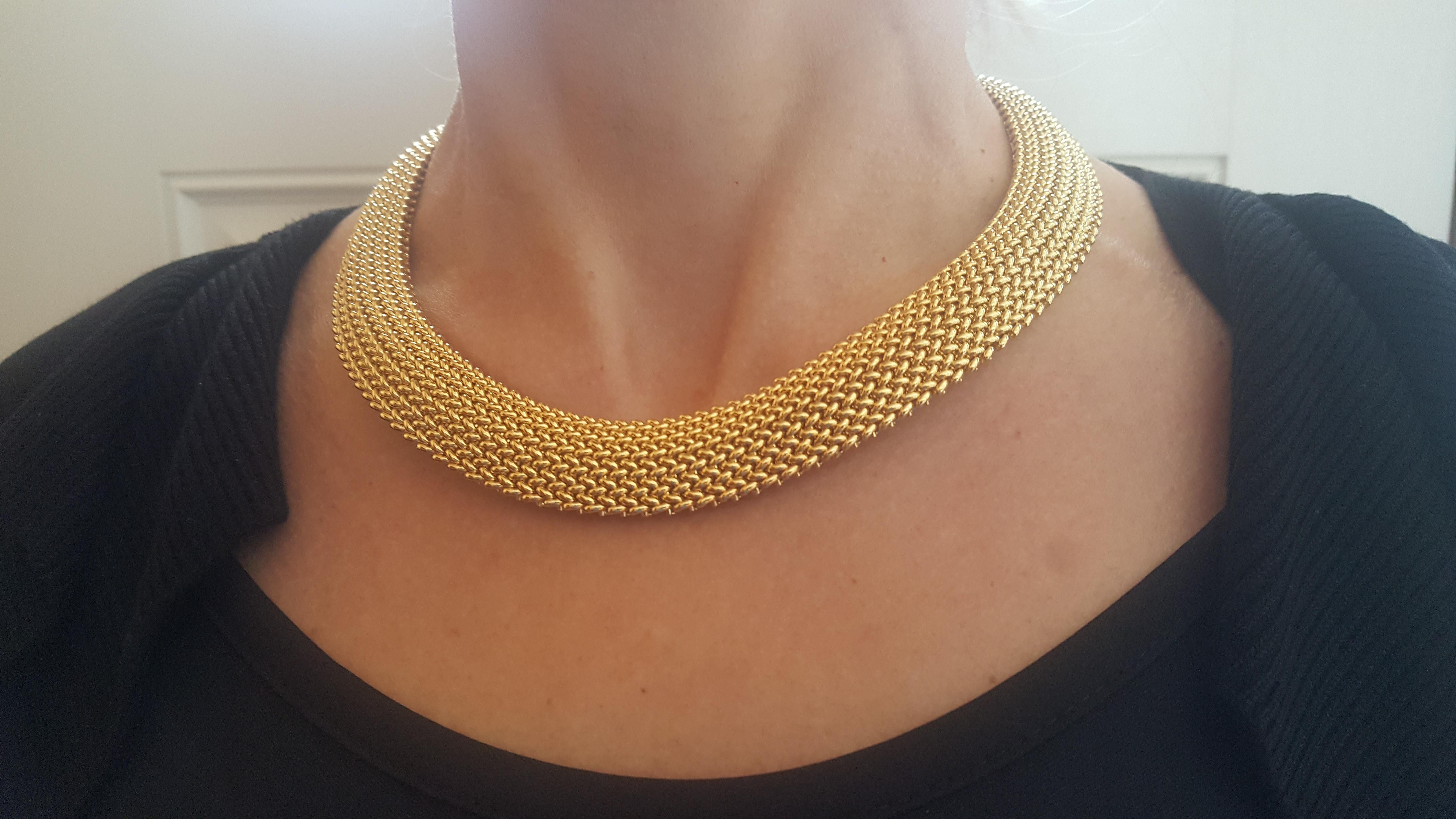14kt yellow gold omega style necklace with a mesh design 18 inches in length and 18.8mm wide. This necklace is 108.73 grams total which is almost 2 ounces of pure gold. Excellent condition and hardly worn, secured with a push in clasp and a safely
