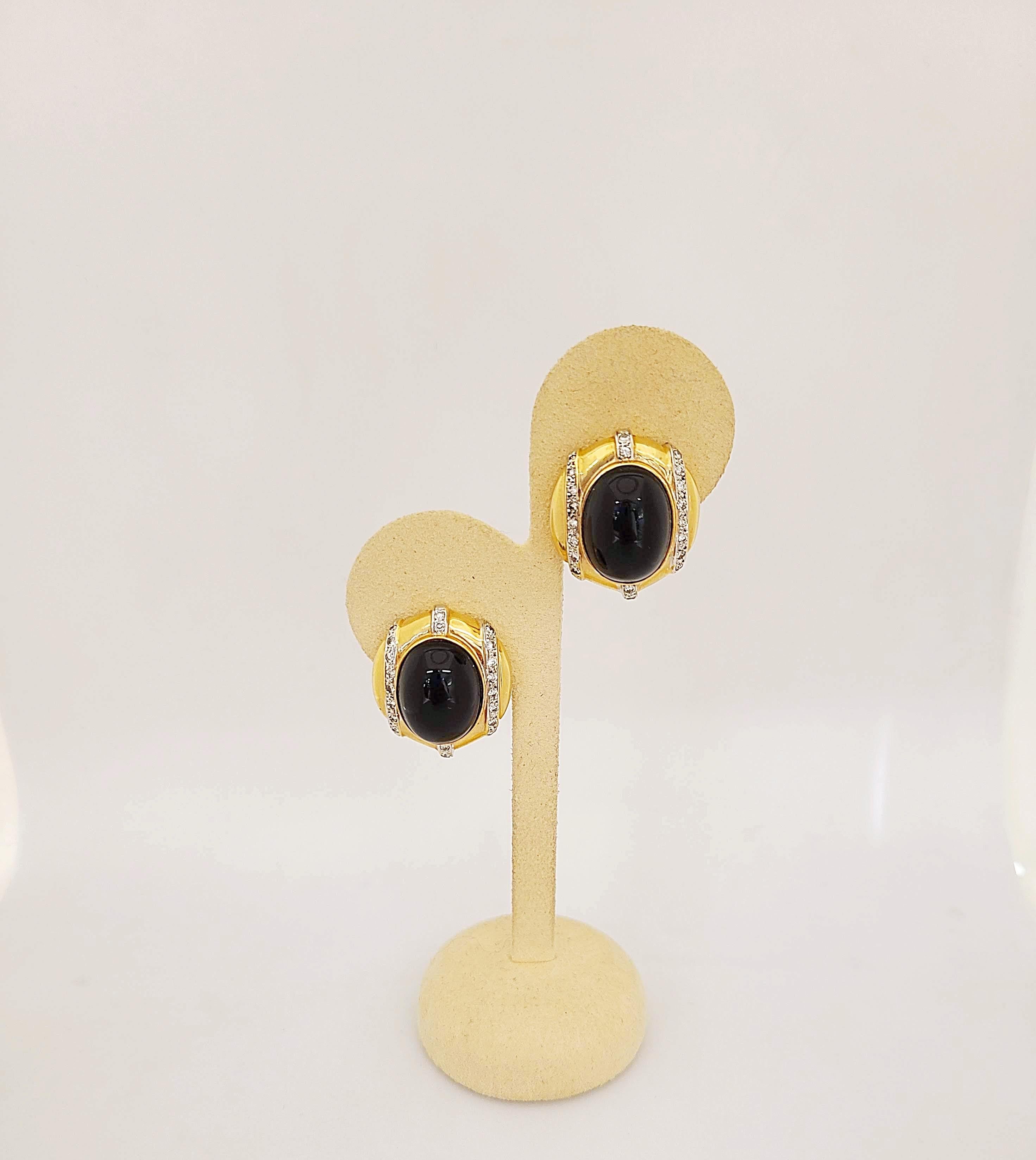 14 karat yellow gold earrings set with oval black onyx centers. Round brilliants diamonds set in white gold accent this lovely pair of button earrings. The earrings have post/omega backs.
Approximately 1