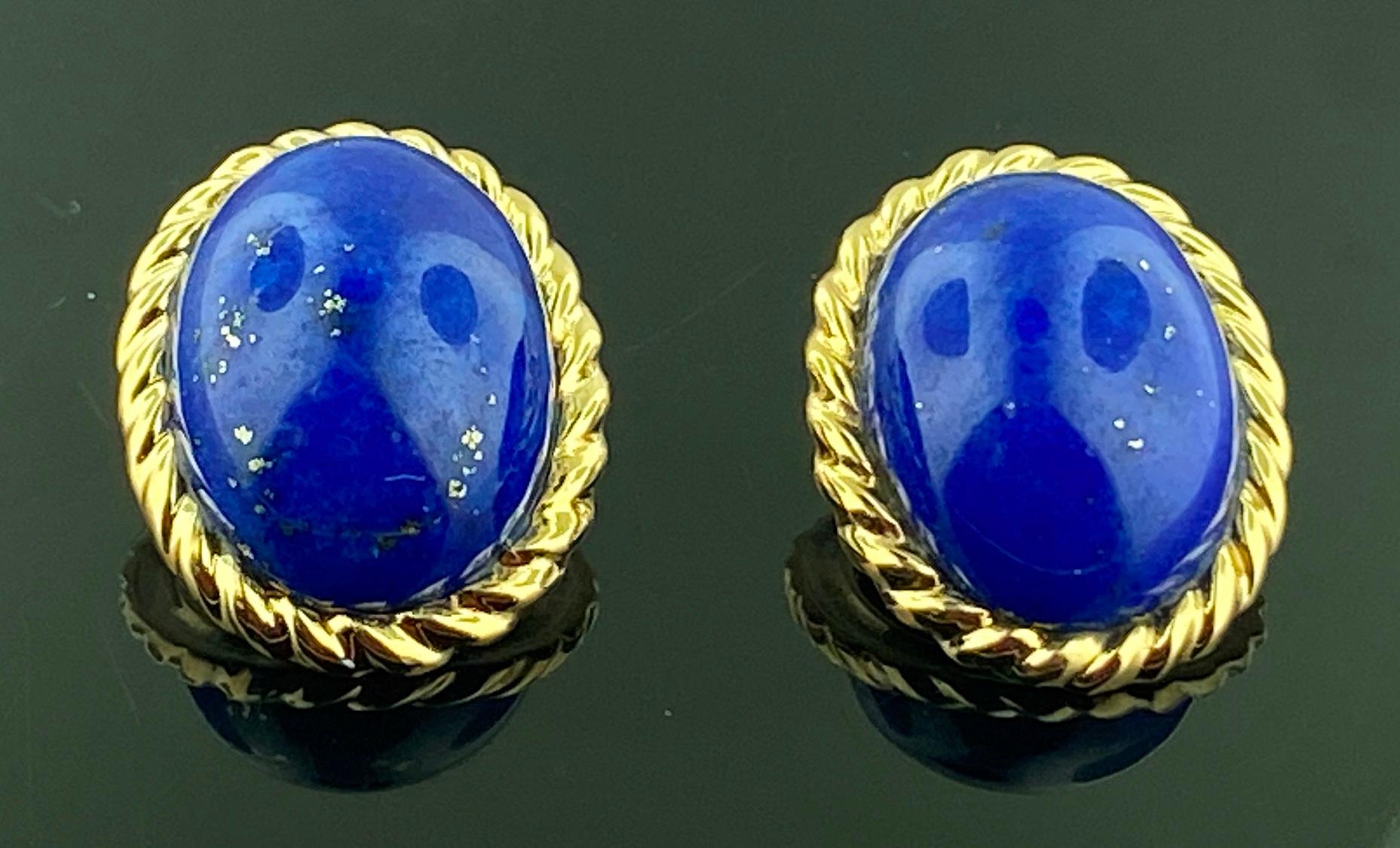 Set in 14 karat yellow gold, weighing 11 grams, are 2 Oval Cut Cabochon Lapis Lazuli earrings.