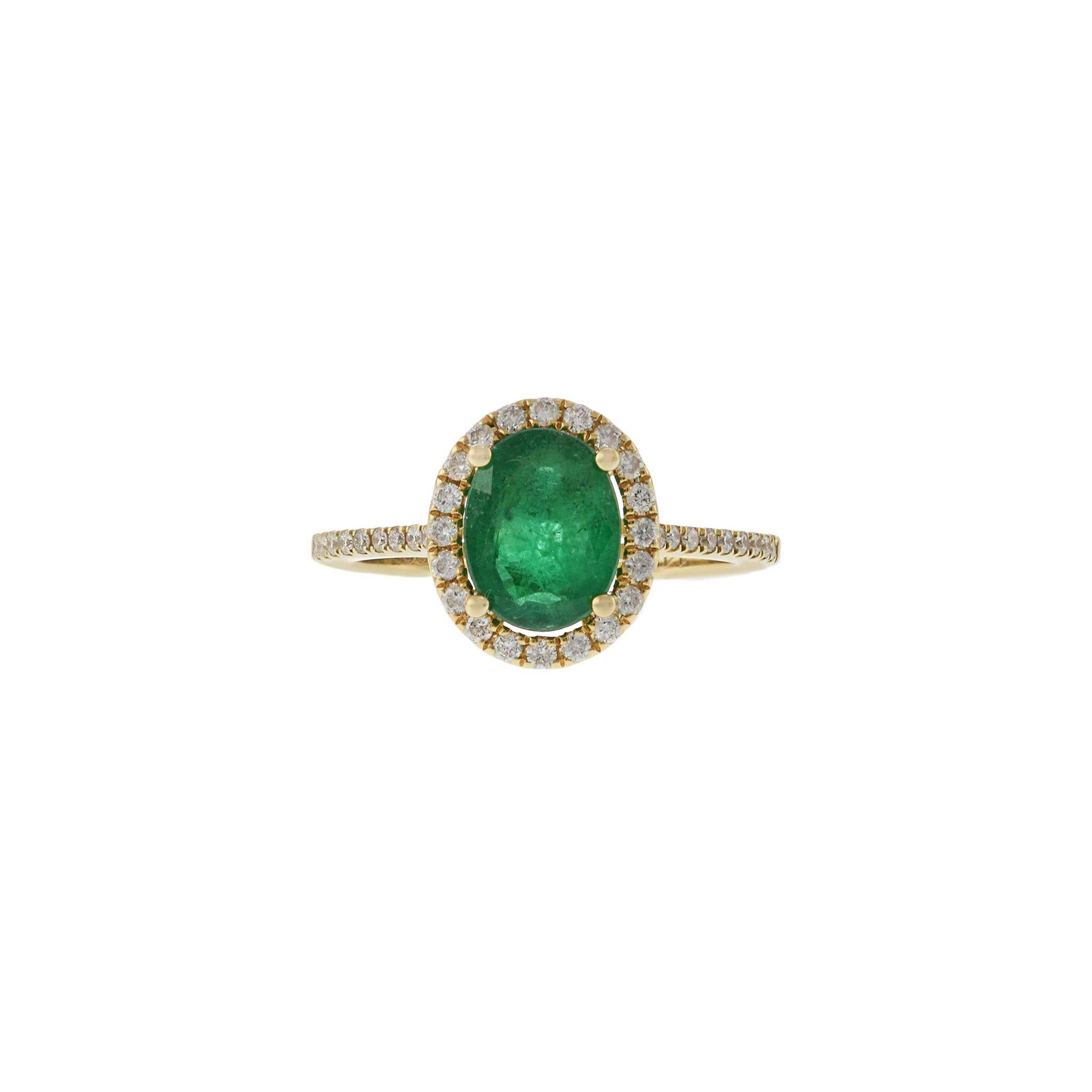 This elegant ring features a 1.64 carat oval cut emerald, beautifully set in 14KT yellow gold. The vibrant emerald is surrounded by a halo of 0.29 carats of round cut diamonds, adding a touch of sparkle and sophistication. This exquisite design