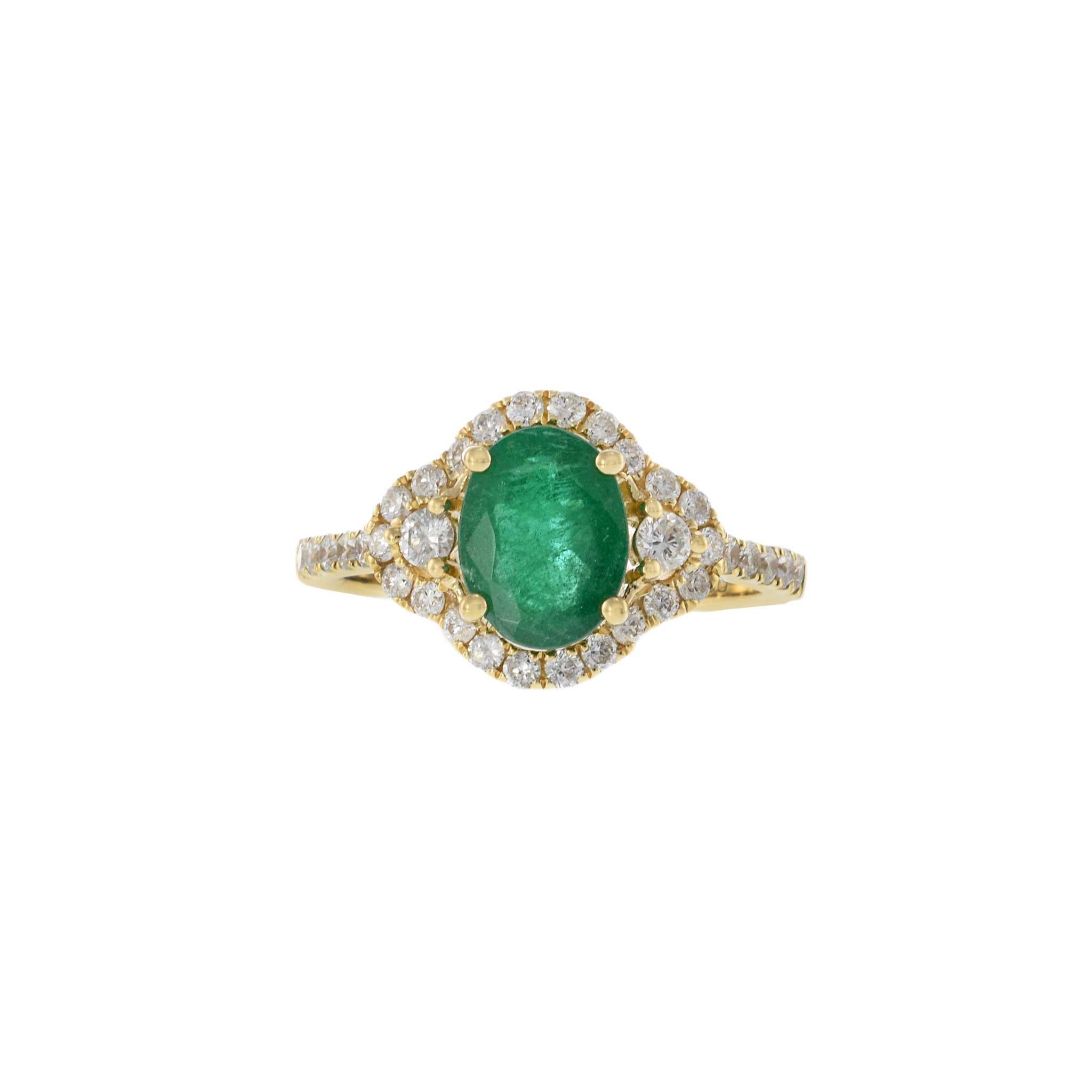 This elegant ring features a 1.73 carat oval cut emerald, beautifully set in 14KT yellow gold. The vibrant emerald is surrounded by a halo of 0.65 carats of round cut diamonds, adding a touch of sparkle and sophistication. This exquisite design