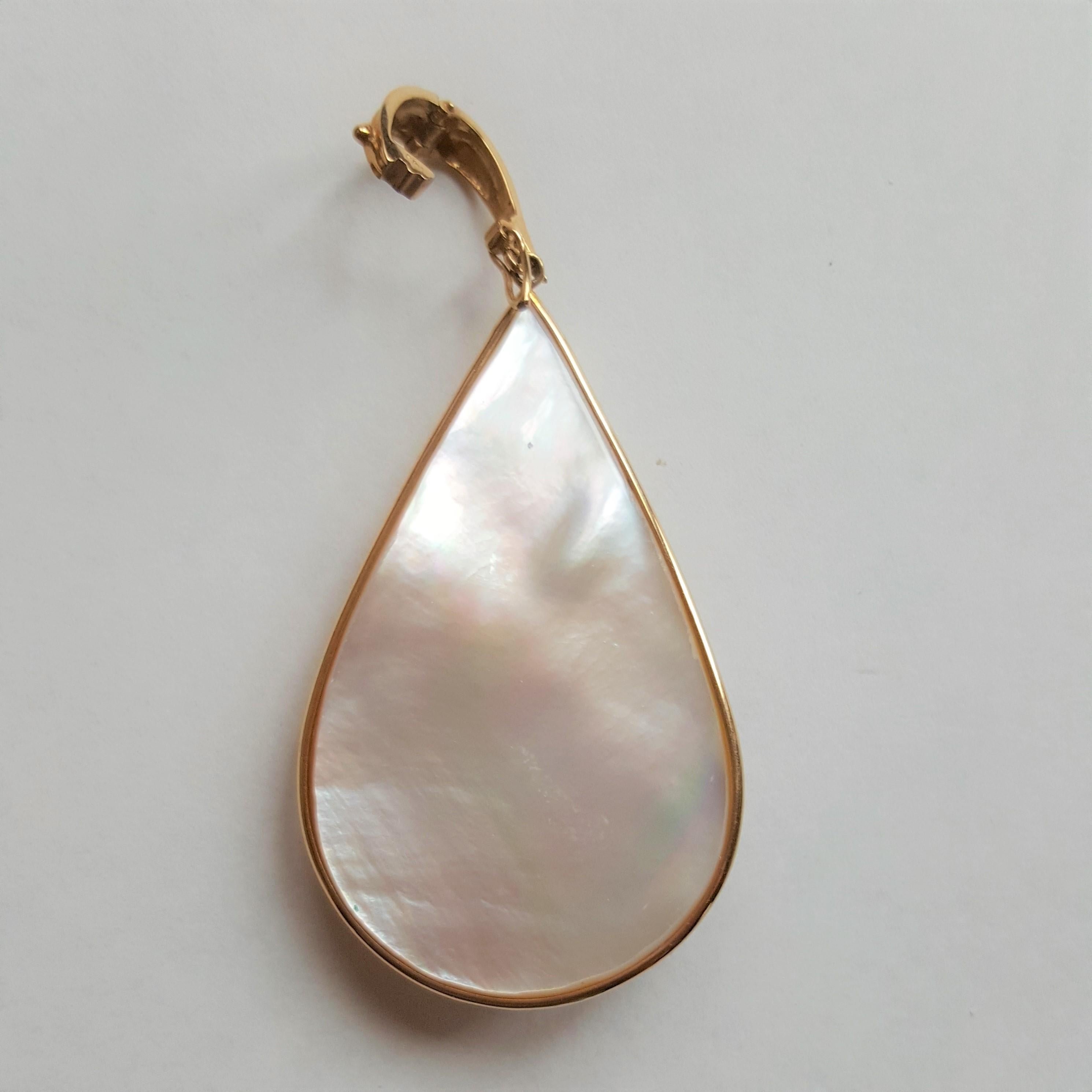 14kt yellow gold wire bezel pendant/enhancer holding a beautiful fine lustrous pear-shaped mabe pearl with very rich clean nacre. The pearl is accented with freeform gold wire and two pear-shaped gemstones; amethyst and peridot. This pendant is in