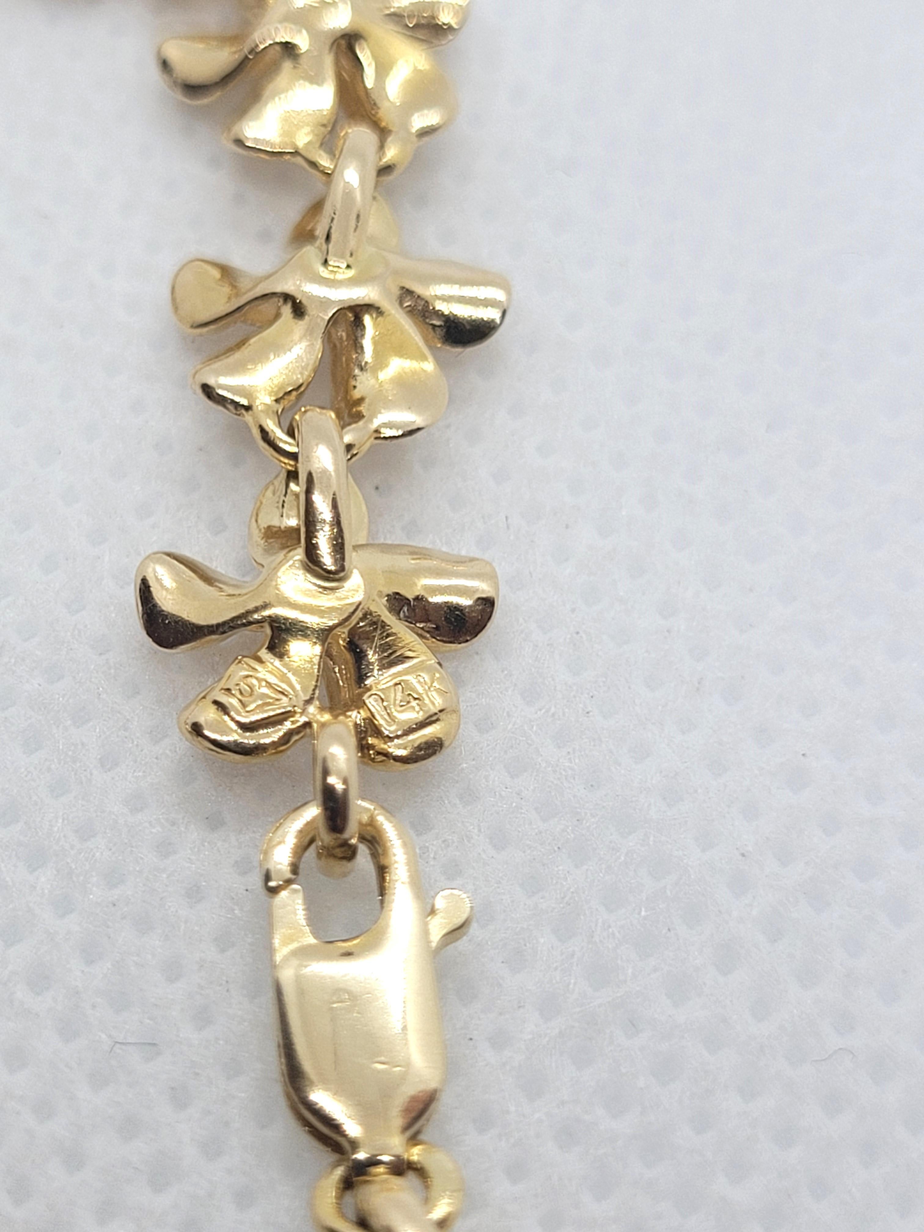 Beautiful 14kt yellow gold plumeria flower link bracelet that is 6.5 inches in length, 9.36mm wide, and 3.4mm thick. The bracelet weighs 8.5 grams, is secured with a lobster clasp, stamped 14kt yellow gold, and overall, is in very good condition.