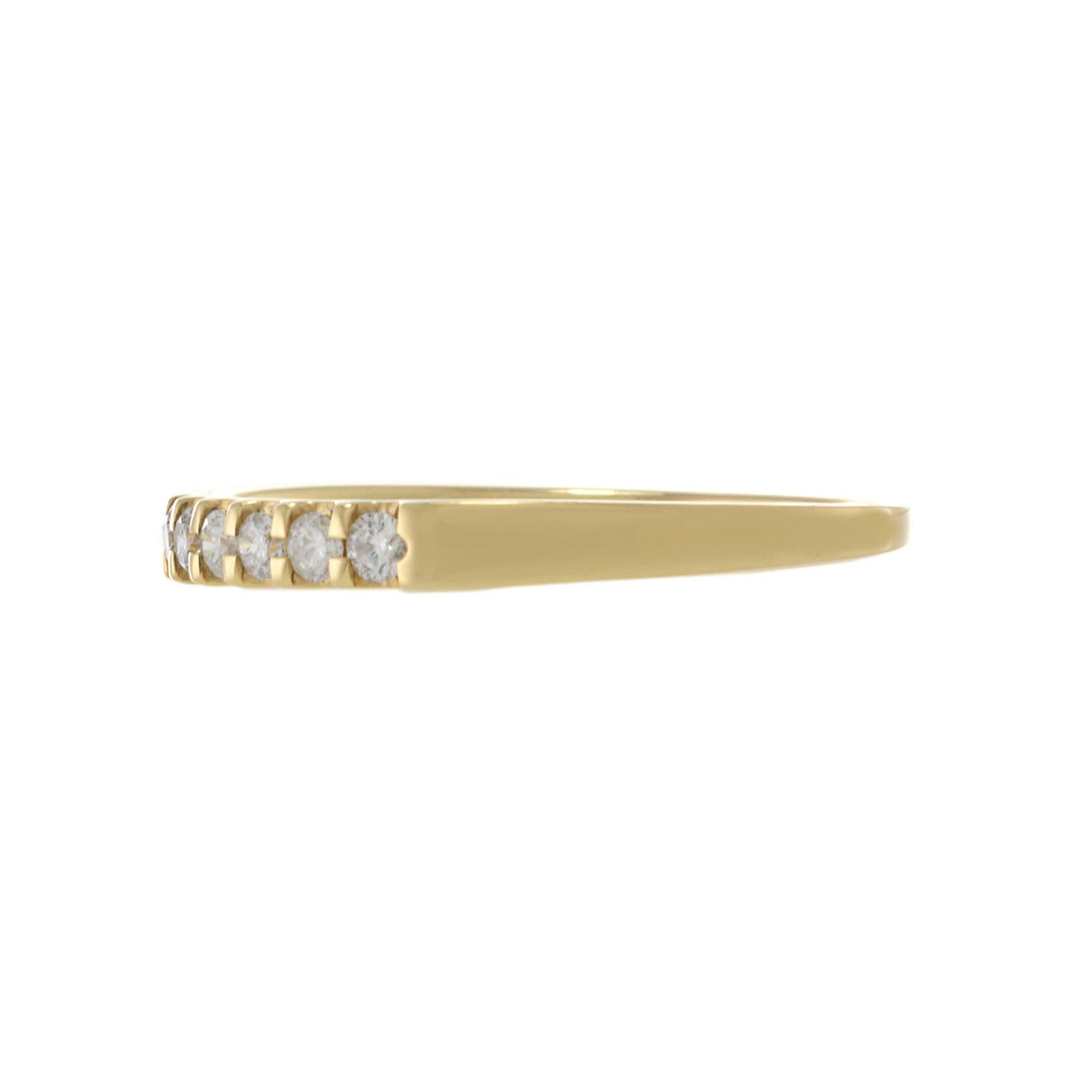 This classic 14KT yellow gold band showcases a single row of prong-set round brilliant cut diamonds, totaling 1.00 carat, with a G-VS clarity and color grade. The timeless design features a sleek, polished yellow gold band, making it a versatile