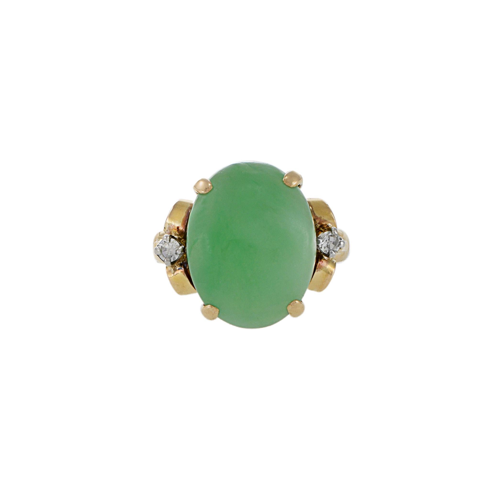 This beautifully crafted retro era ring, crafted in 14KT yellow gold, combines a classic style with genuine, oval cabochon green jade and 0.14CT-TW round brilliant cut diamonds for a timeless look. Size 5.75 US. Weight 6.8 gm.