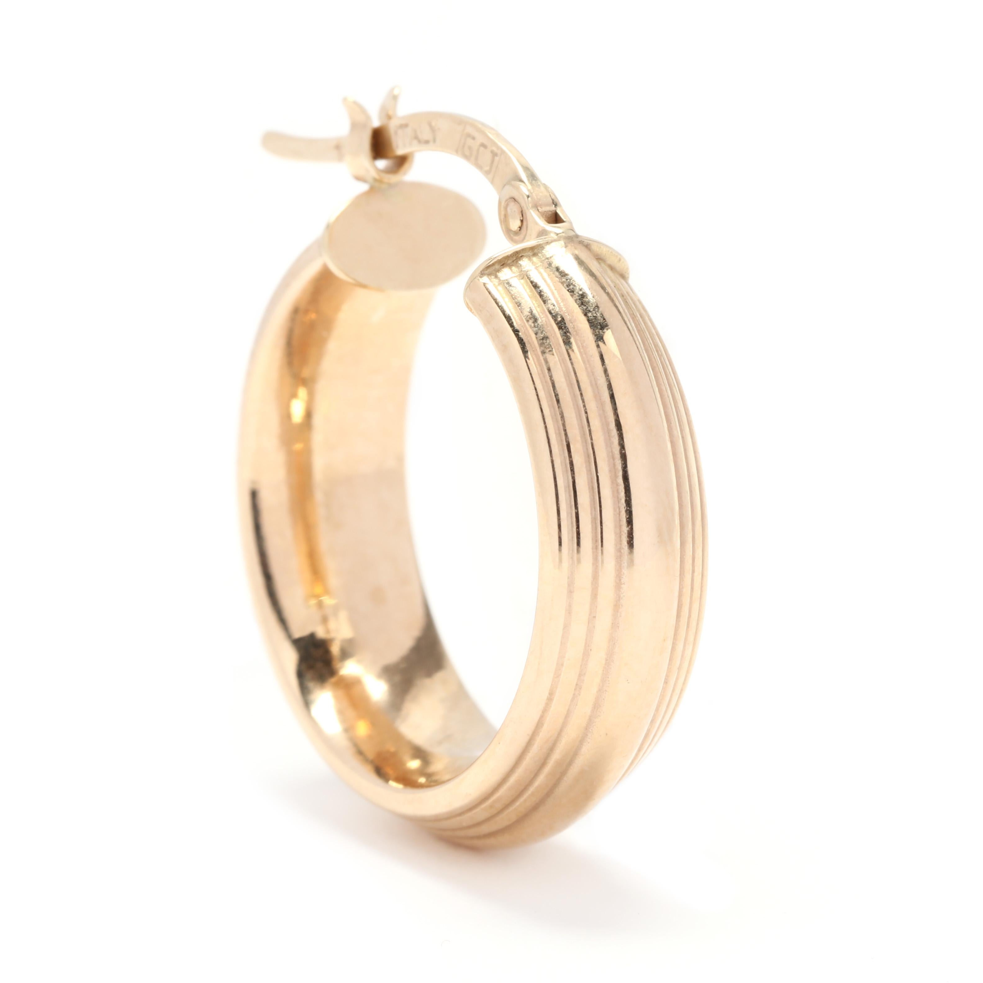 A pair of 14 karat yellow gold ridged knife edge hoop earrings.  These hoops features a knifed edge design with ridged, columned motif and snap closures.

Length: 3/4 in.

Width: 6 mm

1.7 dwts.

A Couple Of Things to Note:
* This is a vintage item