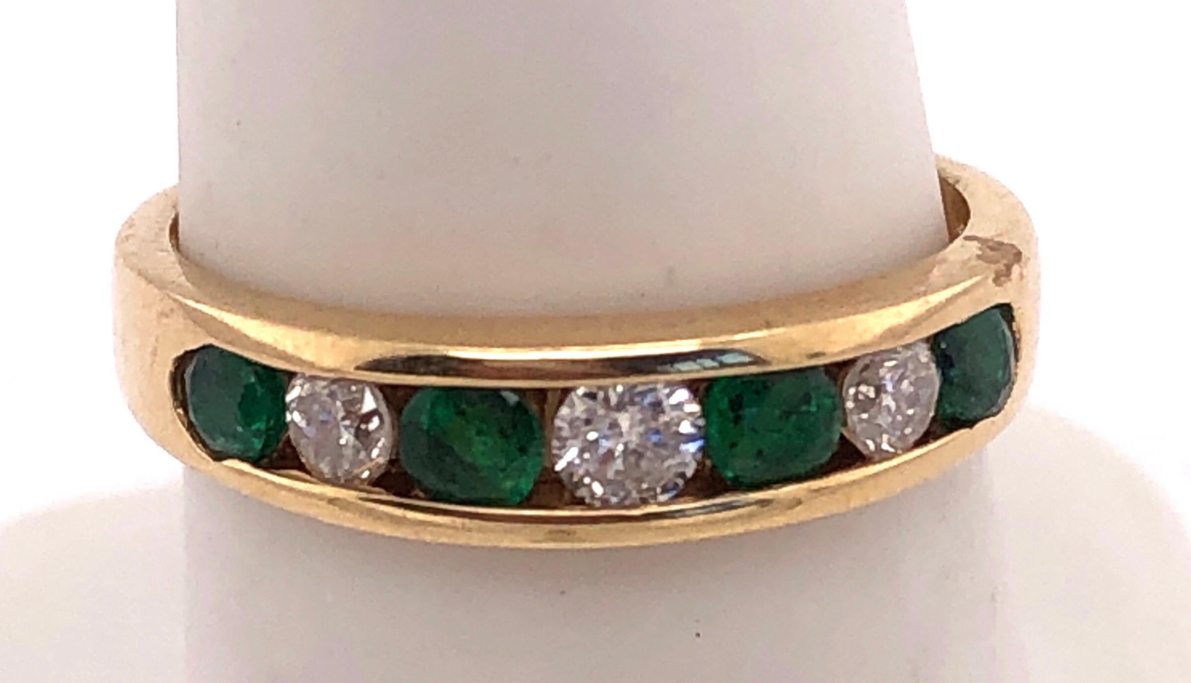 14Kt Yellow Gold Ring Or Wedding Band with Seven Stones Emerald and Diamond
Size 6.7 
0.36 TDW
3 grams total weight.