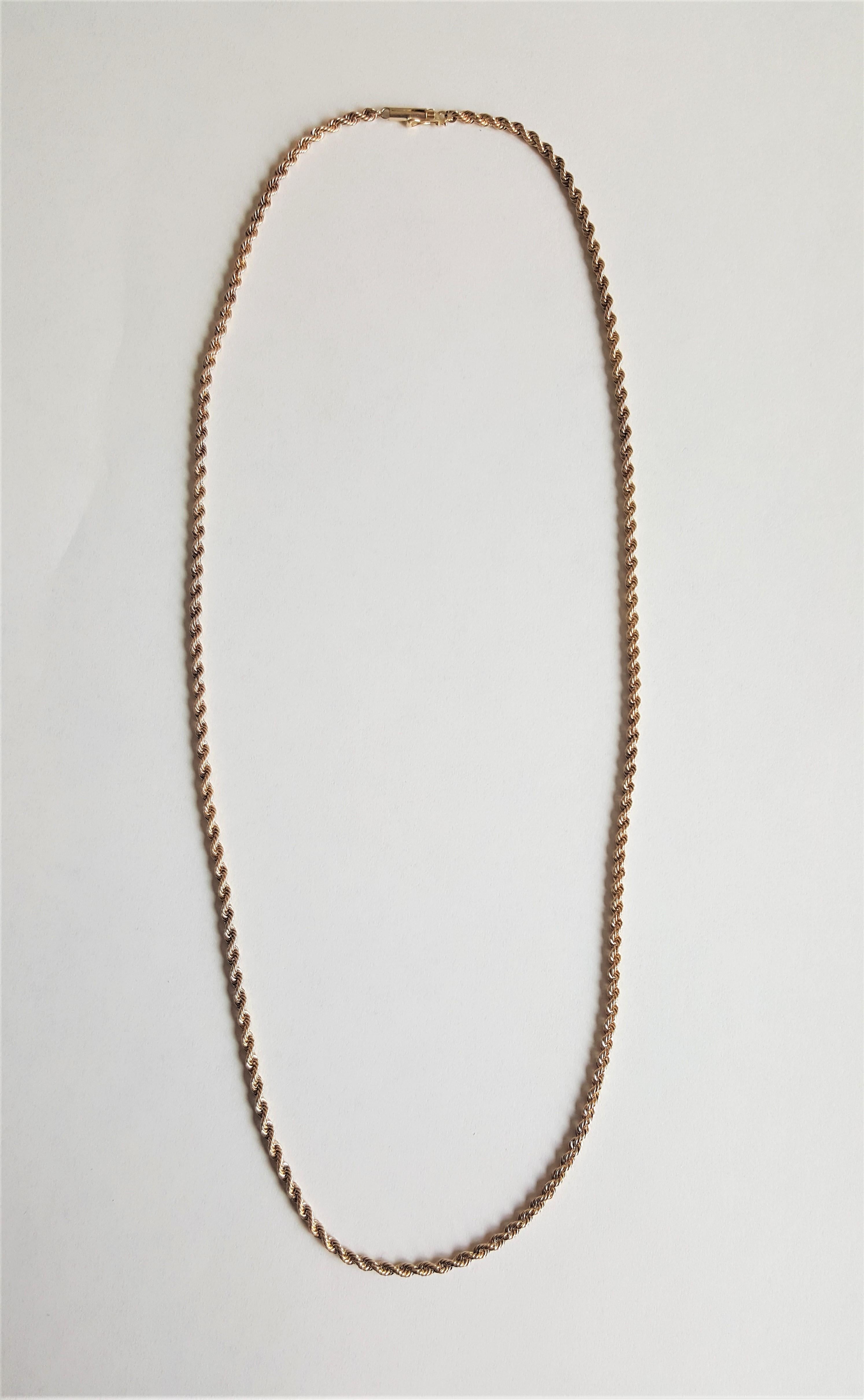 14kt yellow gold rope chain that is 24 inches long, secured with a barrel clasp and safety chain. The chain is in very good condition, 1.3mm in width, and weighs 18.3 grams. This is a great versatile chain. Please let us know if you have any