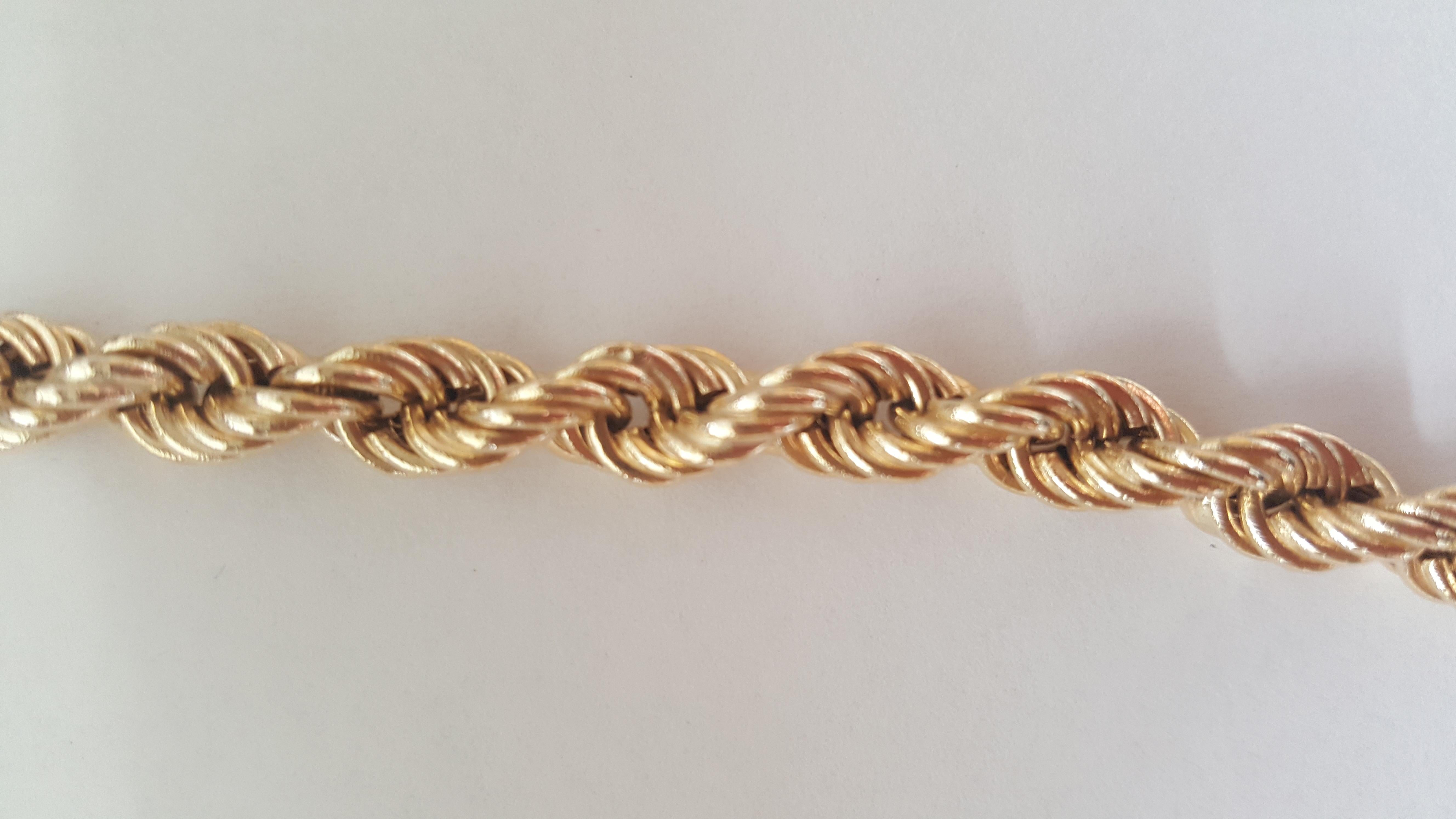 14kt yellow gold rope chain that is 30 inches in length, 6.6mm wide, weighs 42.3 grams, is hollow, and in very good condition. Secured with a push-in clasp and secured with figure-8 latch, stamped 14kt. Very good condition.

A versatile chain that