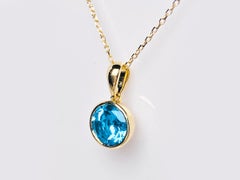 Collana con ciondolo solitario con castone in oro giallo 14KT con taglio rotondo in Topazio Blu Svizzero