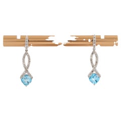 Orecchini pendenti Infinity con diamante rotondo e topazio blu in oro giallo 14KT