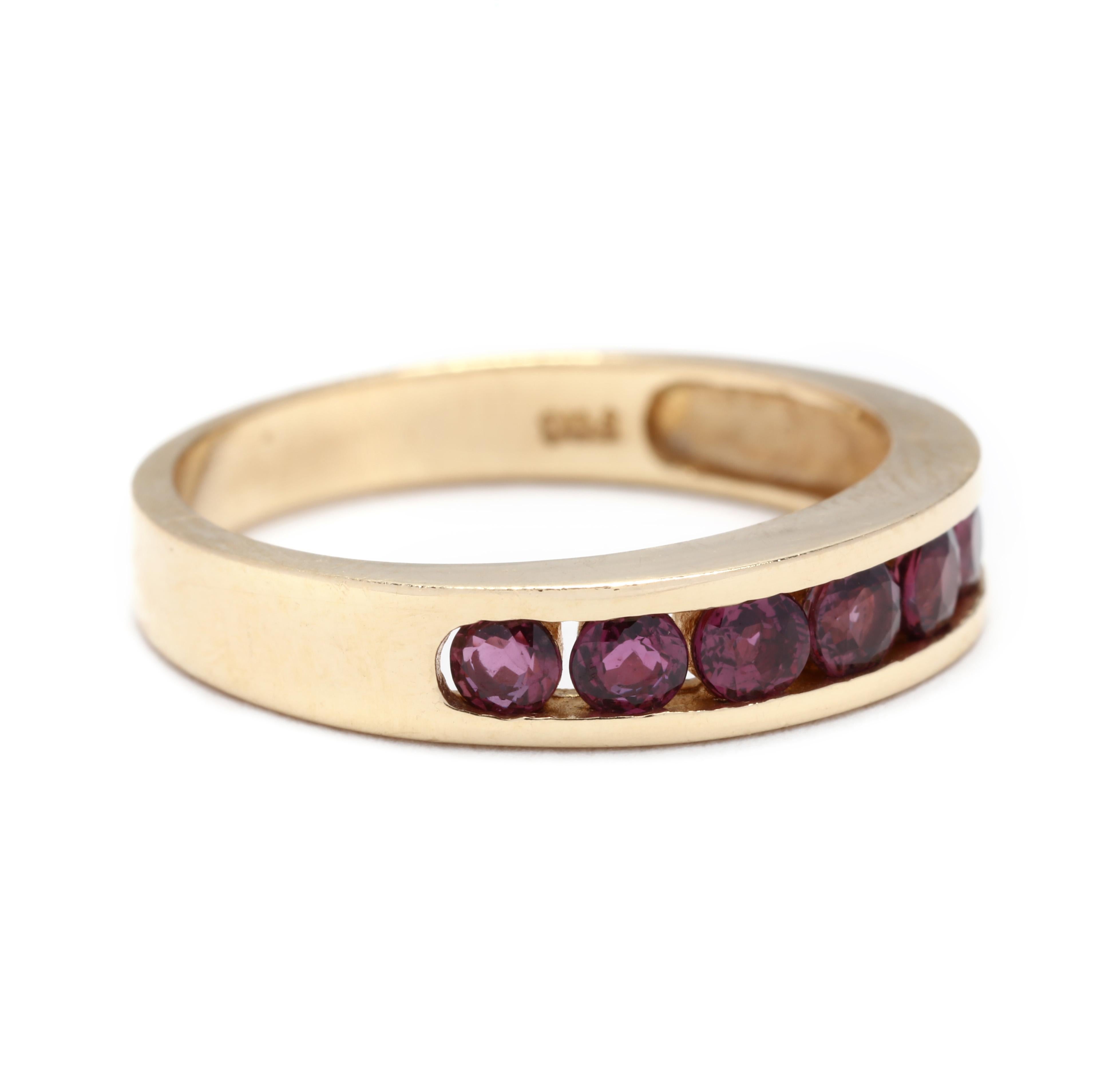 A 14 karat yellow gold ruby channel set band. A tapered band, with seven channel set round cut rubies weighing approximately .50 total carats and a polished shank.

Stones:
- rubies, 7 stones
- round cut
- 2.5 - 2.75 mm
- approximately .50 total