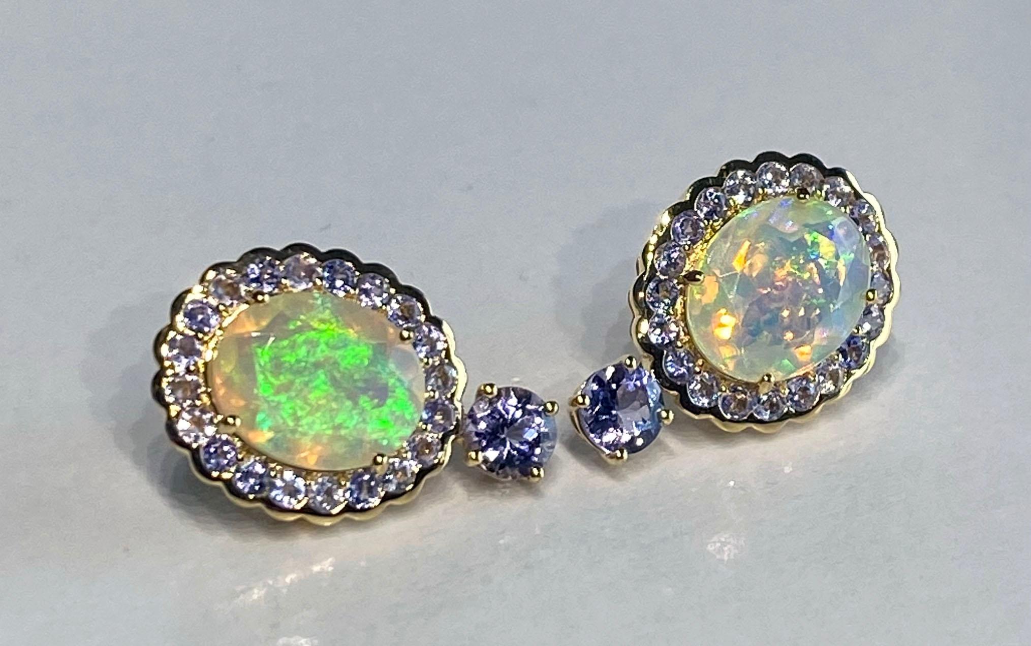 14kt Yellow Gold Earrings with Tanzanite & Crystal Opal
These lovely earrings are set with 40, 2.5 MM Round Brilliant Tanzanites & 2, 4MM Round Brilliant Tanzanites, Two Oval Cut 10 x13MM Australian Crystal Opals all set in shining 14kt Yellow