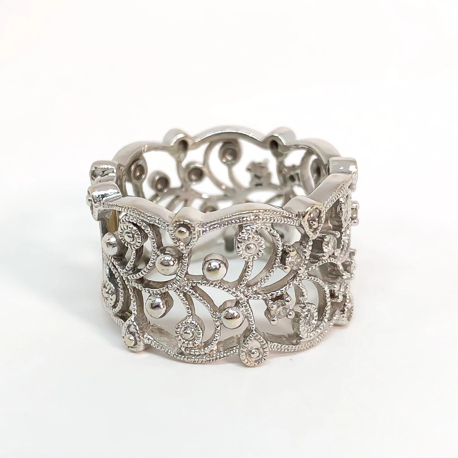 Diamond Filigree Lace Wide Lady’s Band Designed in 14 Karat White Gold. Beautiful lace cutout filigree with scattered diamonds on the top half of the ring. Diamonds are approximately I color, SI2-I1 clarity. .35 carats total weight.

✦ Ring measures
