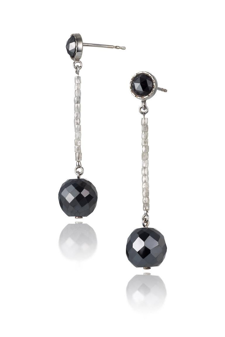 14KW black and white diamond earrings are 9.71 carats.  White gold bezel surrounds two rosa cut black diamonds on a string of white pipe cut diamonds beads, at the end is a large faceted cut black diamond wrecking ball.  These diamond wrecking ball