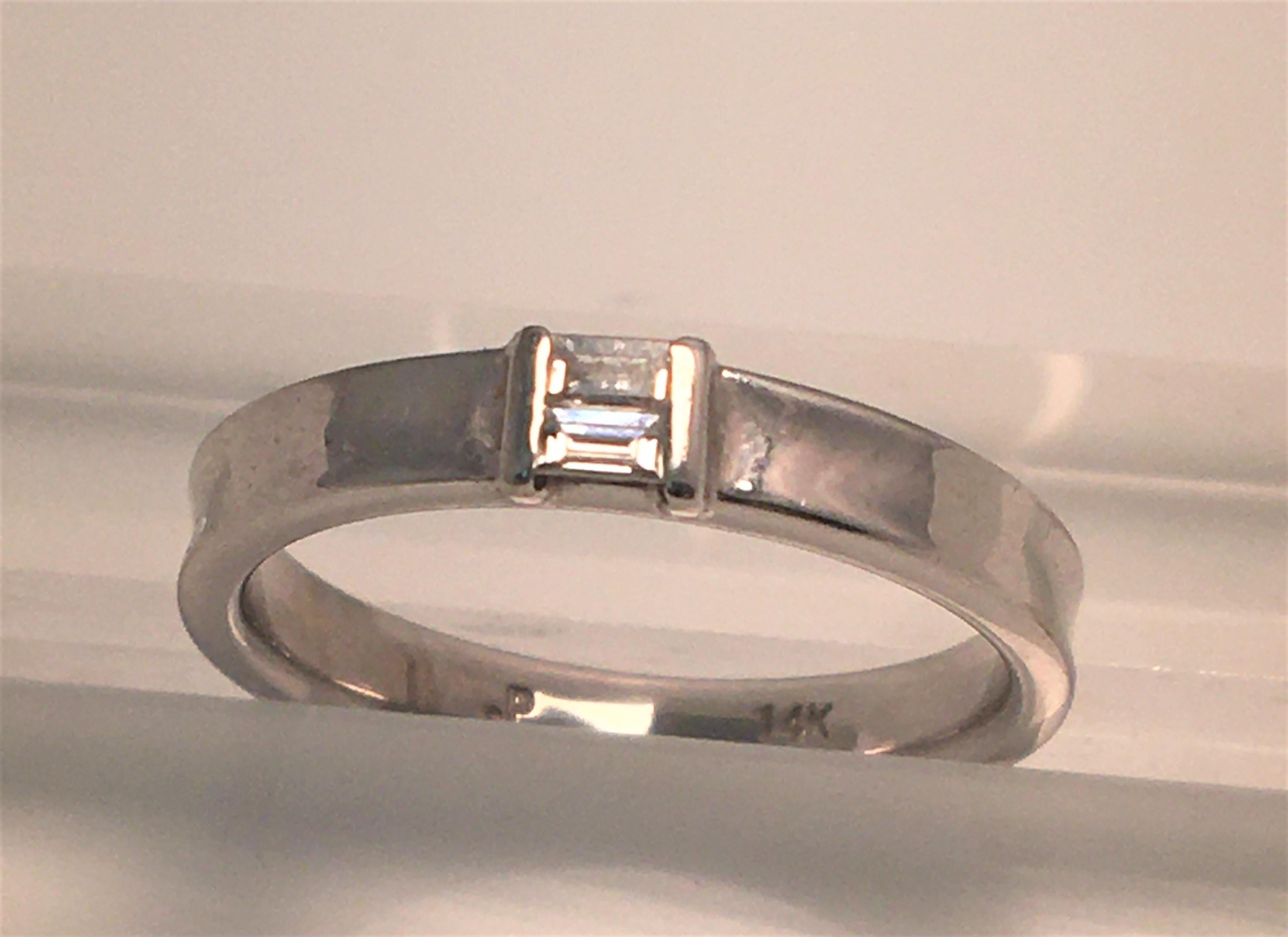 By designer Paolo, known for his modern designs
14 karat white gold band, approximately 3mm wide all the way around, concave
2 baguette diamonds approximately .08 tdw, G-H color, SI clarity
Size 5
Stamped 