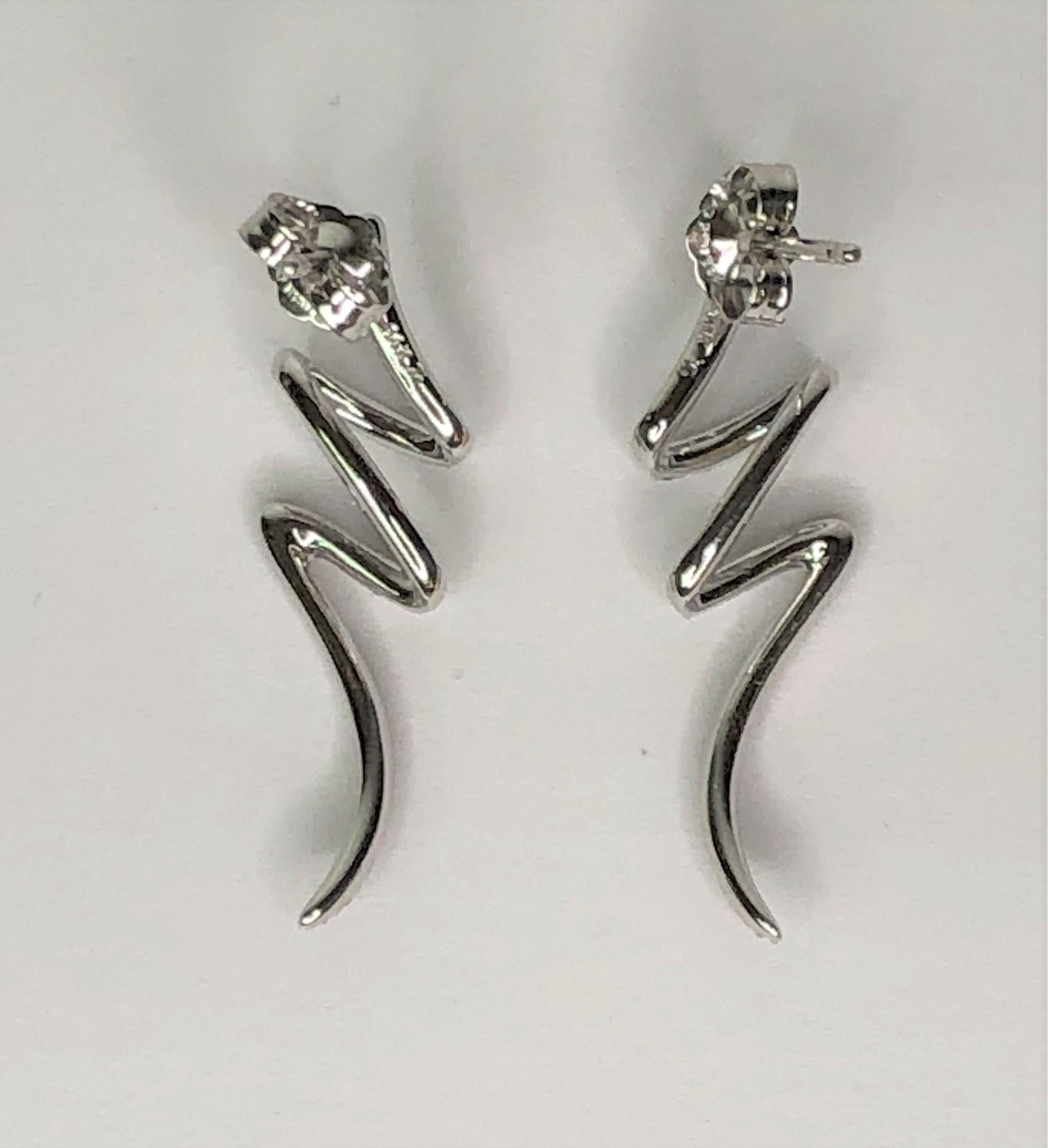 These fun earrings will make everyone smile!!  
14 karat white gold squiggle design lined with diamonds. 
Total of 33 round cut diamonds on each earring.  
.33 total diamond weight
Easy to wear!
Post with friction back.
Stamped 
