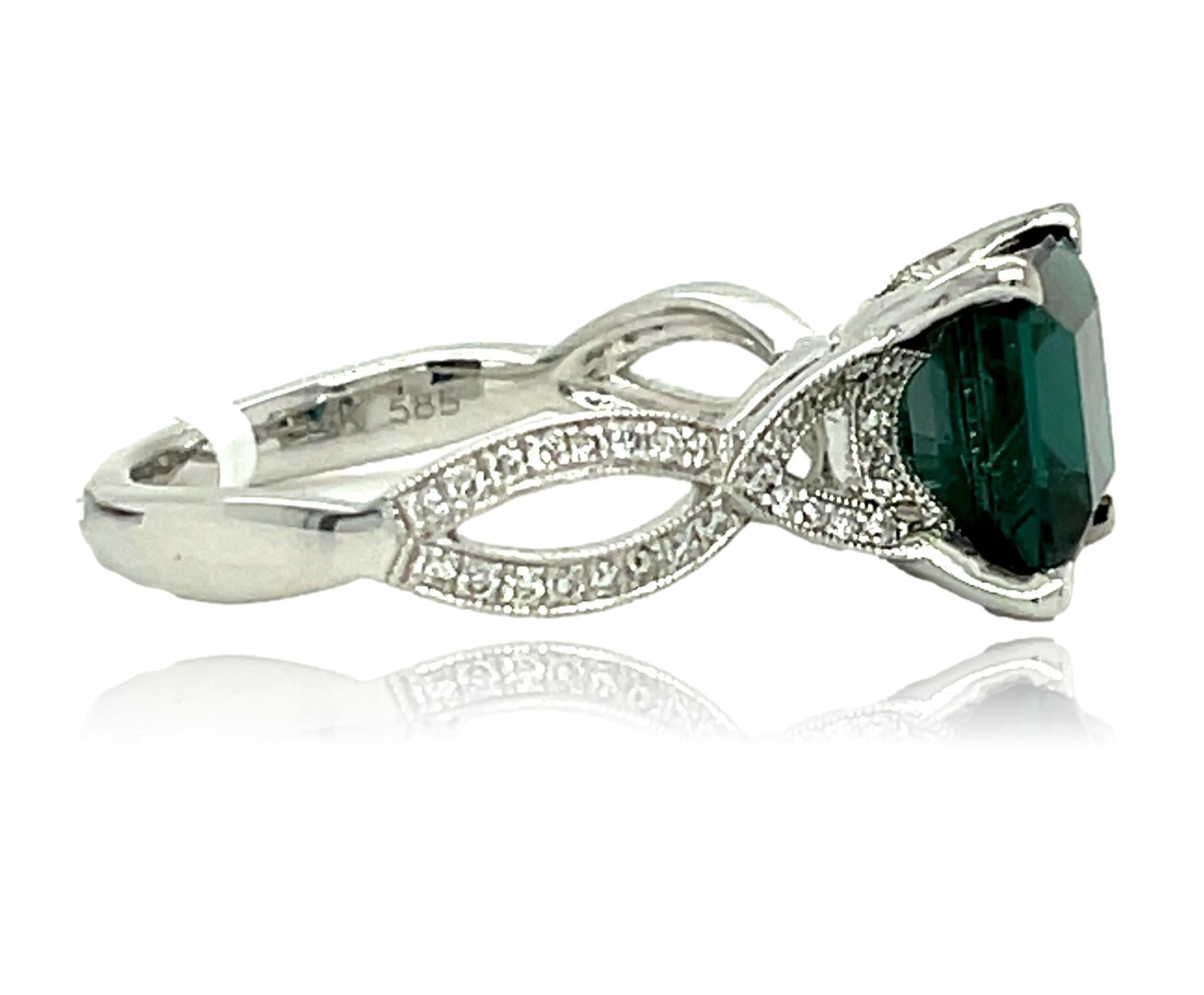 This stunning ring has a deep green Princess cut Green Tourmaline center with top quality diamonds on the shank and is set in 14K white gold. It comes in a beautiful box ready for the perfect gift!

14KW:                          3.50 gms
Green