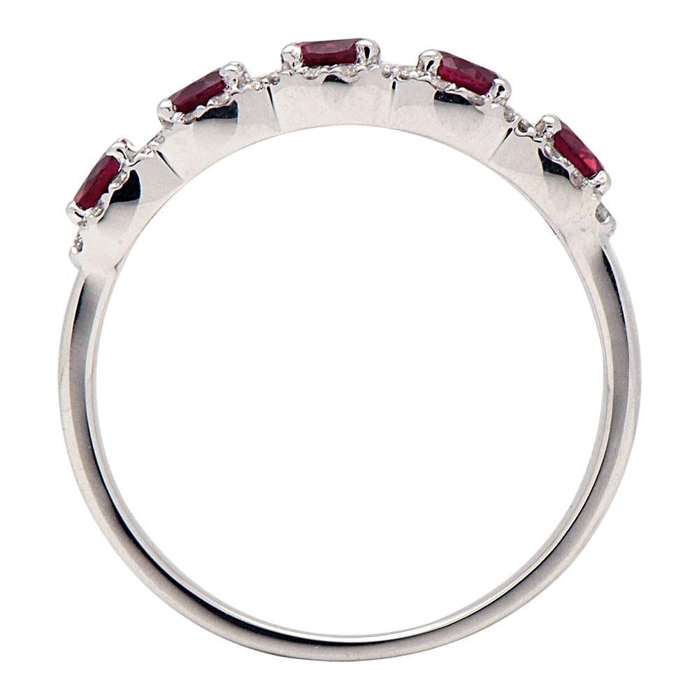 This beautiful band-style ring has 5 round red rubies totaling 0.93 carats which are surrounded by 52 round SI, H color diamonds totaling 0.27 carats which create a beautiful halo around the rubies. This ring is made from 2.4 grams of 14 karat white