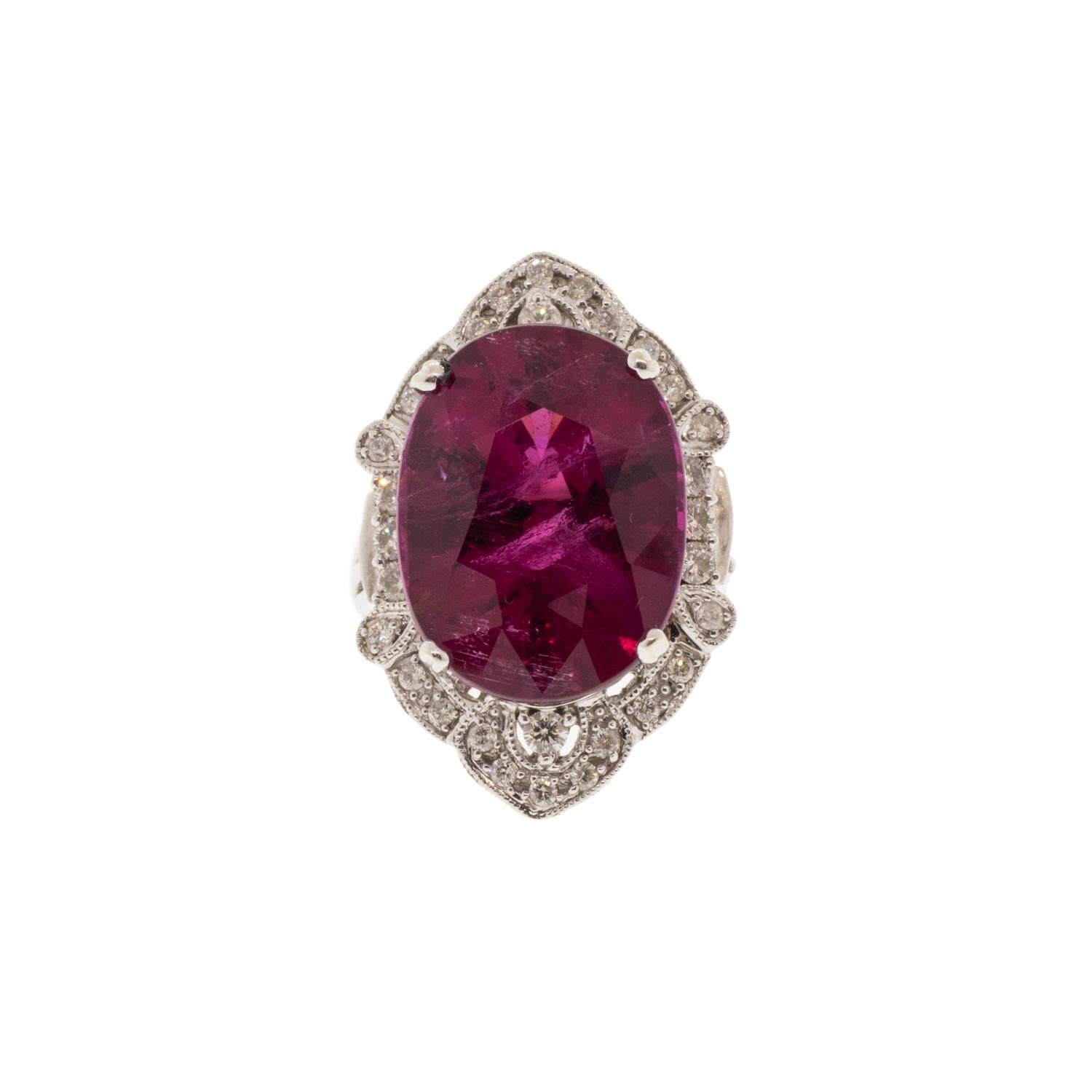 This 16.54ct natural rubellite tourmaline and diamond halo ring is a true showstopper. Crafted from 14k white gold, its vintage design is sure to make a unique addition to any jewelry collection. Its rubellite center stone is surrounded by a