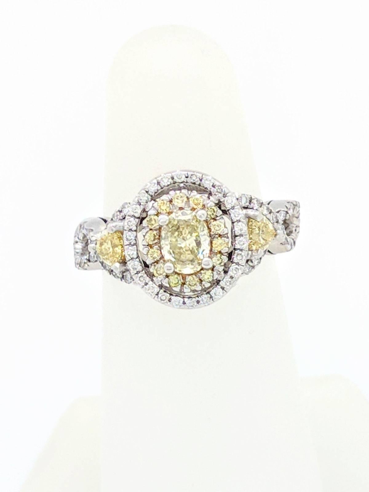 Fancy Yellow & Natural White Diamond Engagement Ring 1.50ctw

You are viewing a Stunning Fancy Yellow & White diamond engagement ring. The center fancy yellow .40ct oval diamond is beautifully displayed in a 14kwg 4-prong halo engagement setting
