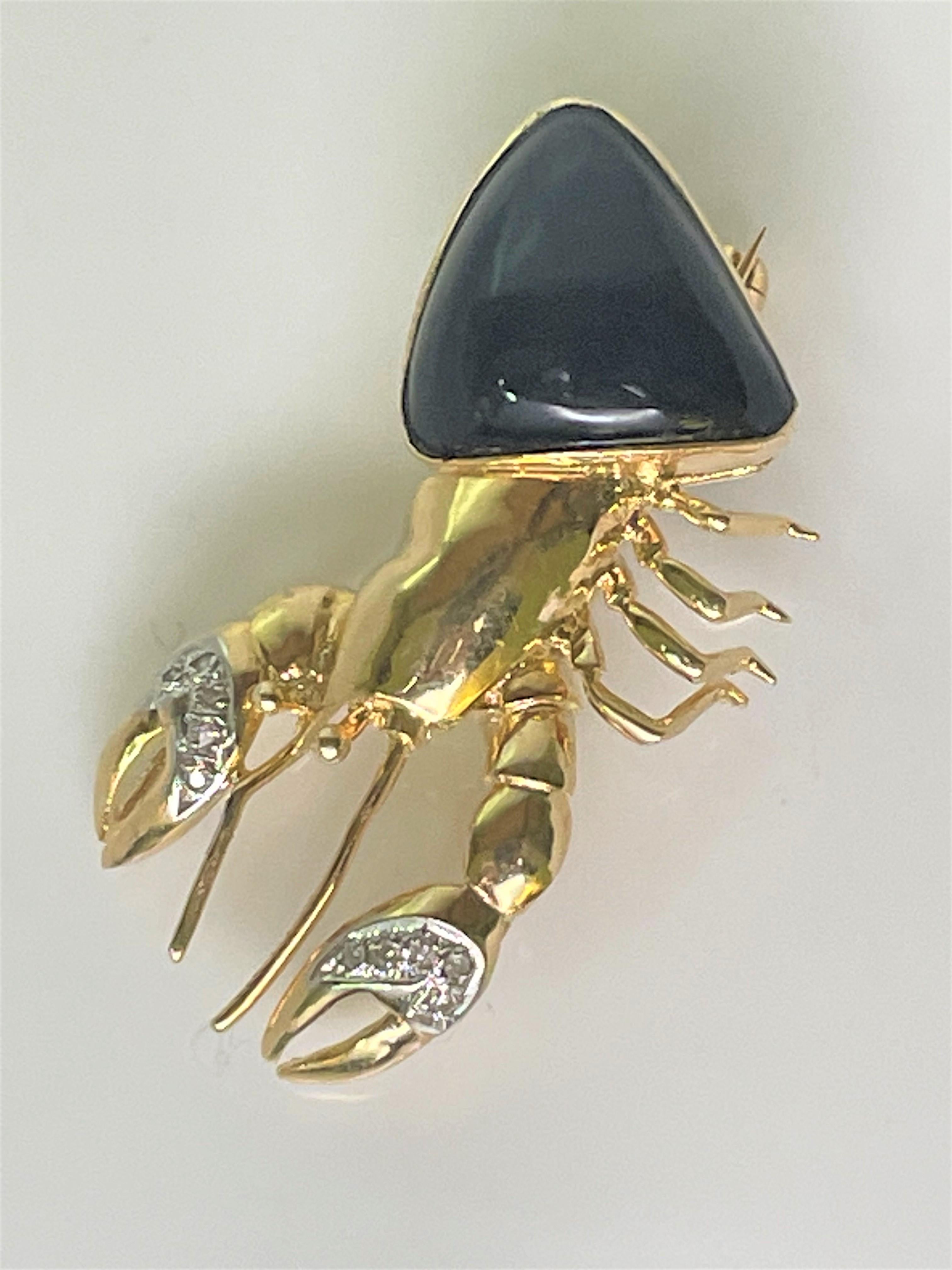 This adorable crab is sure to grab attention!
14 karat yellow gold crab.
Rounded triangle shape black onyx shell.
5 round diamonds adorn each claw.  Approximately .01ct each. 
Hinged pin with safety clasp.  Can also be worn as a pendant.
Crab only,