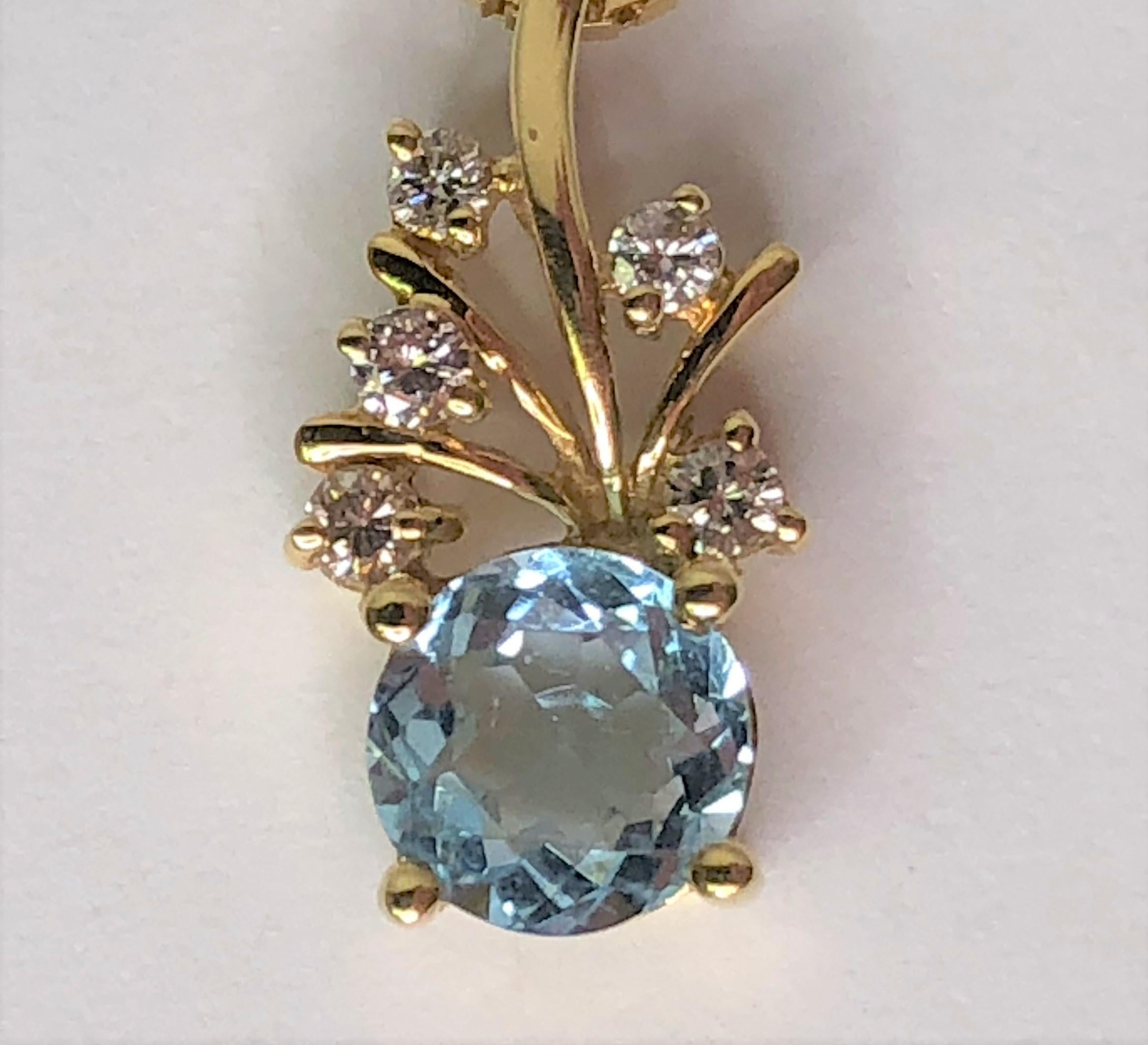 This sparkly necklace is an easy everyday wear!!  
14 karat yellow gold pendant with round blue topaz and 5 round diamonds.
Pendant is a darling 'stem/flower' design with:
One round light blue topaz, prong set, approximately 5.8mm round.
Five round