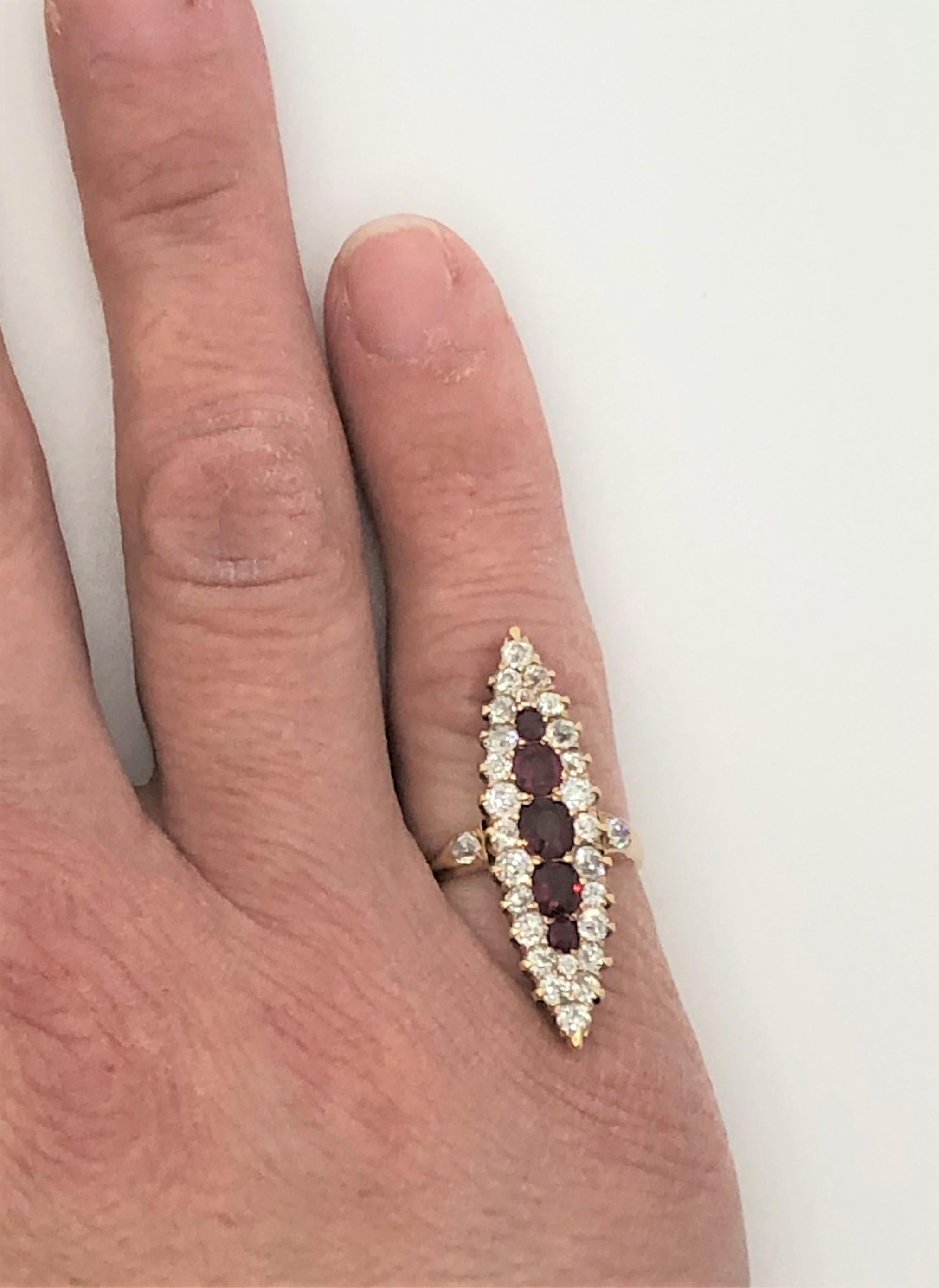 This unique ring is sure to be noticed and can be an every day statement piece.  
14 karat yellow gold vertical setting. 
5 oval rubies graduating from approximately .33ct to .05ct each
28 total round diamonds ranging from approximately .10ct to
