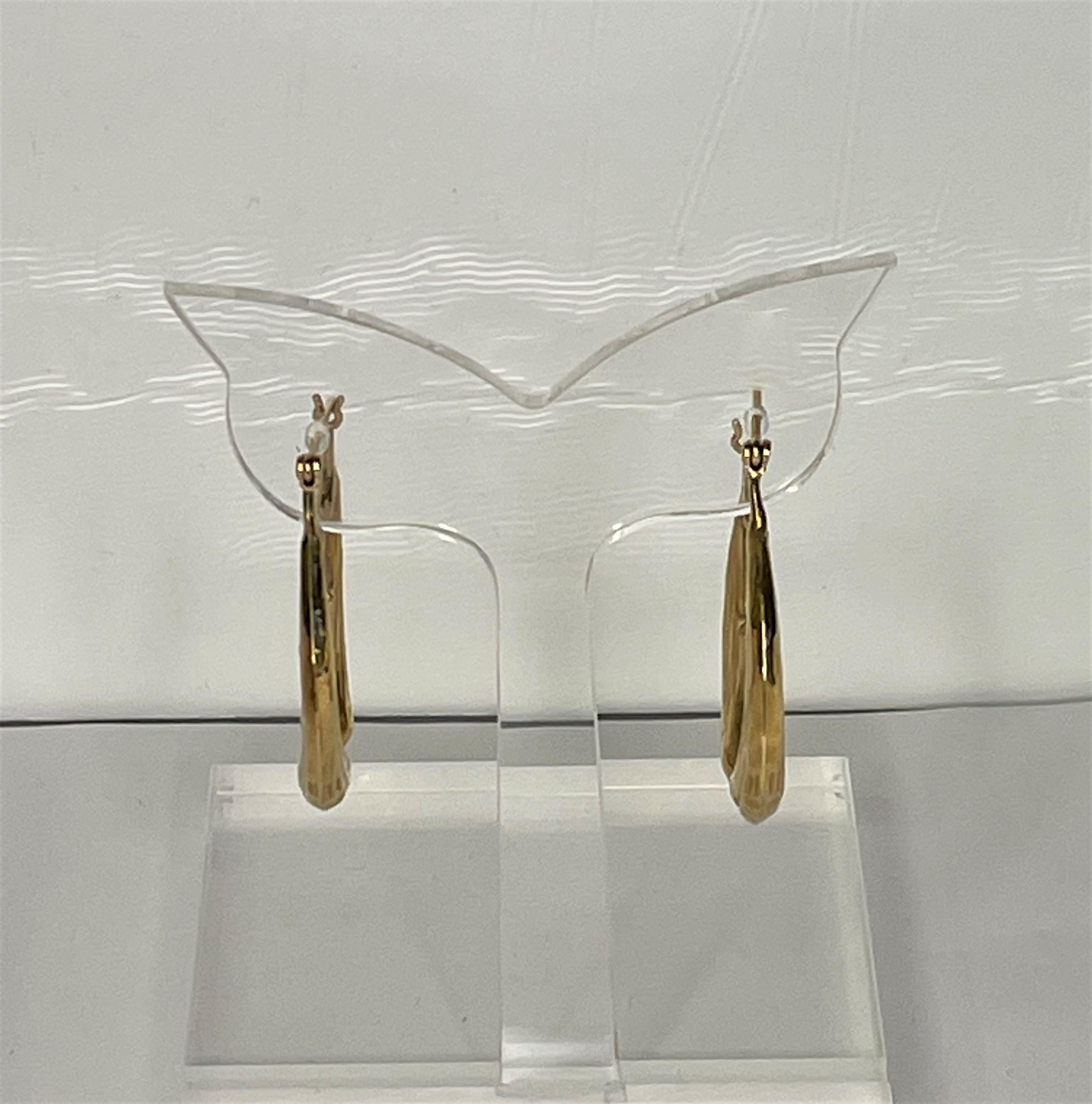 These playful earrings will be a favorite for anyone who likes dophins!
14 karat yellow gold.
Each earring has two dolphins tails up, noses touching a small ball at the bottom of the hoop.
Hinged post.
Approximately 33mm x 27mm
2.4dwt
Stamped 