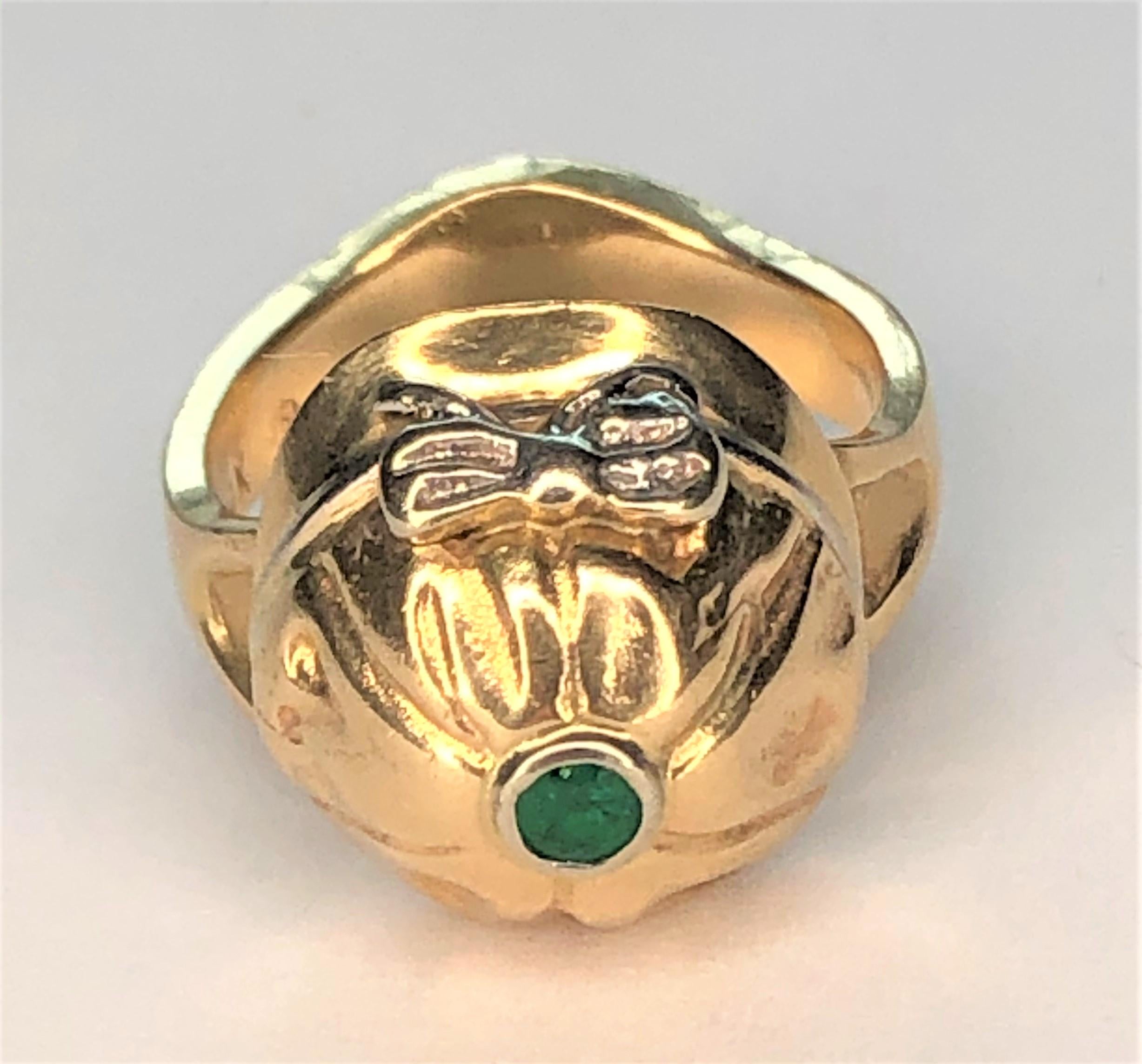 This adorable ring will be the perfect piece for anyone loving horses!
14 karat yellow gold 3mm band that increases to approximately 7mm at the bottom, an area that could be engraved. 
Small round emerald on top of hat.  Approximately 3mm round.