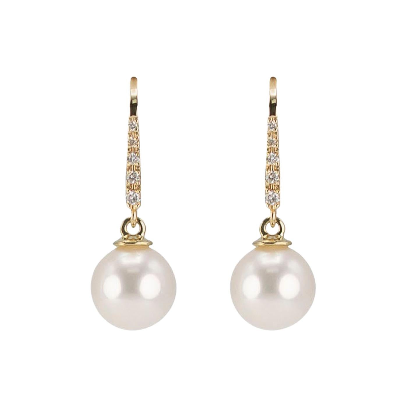 Be the belle of any ball with these stunningly romantic pure white cultured pearl earrings. Each dangle earring features a lustrous pure white genuine cultured freshwater pearl in a perfectly round shape. Each pearl drop hangs below a line of five