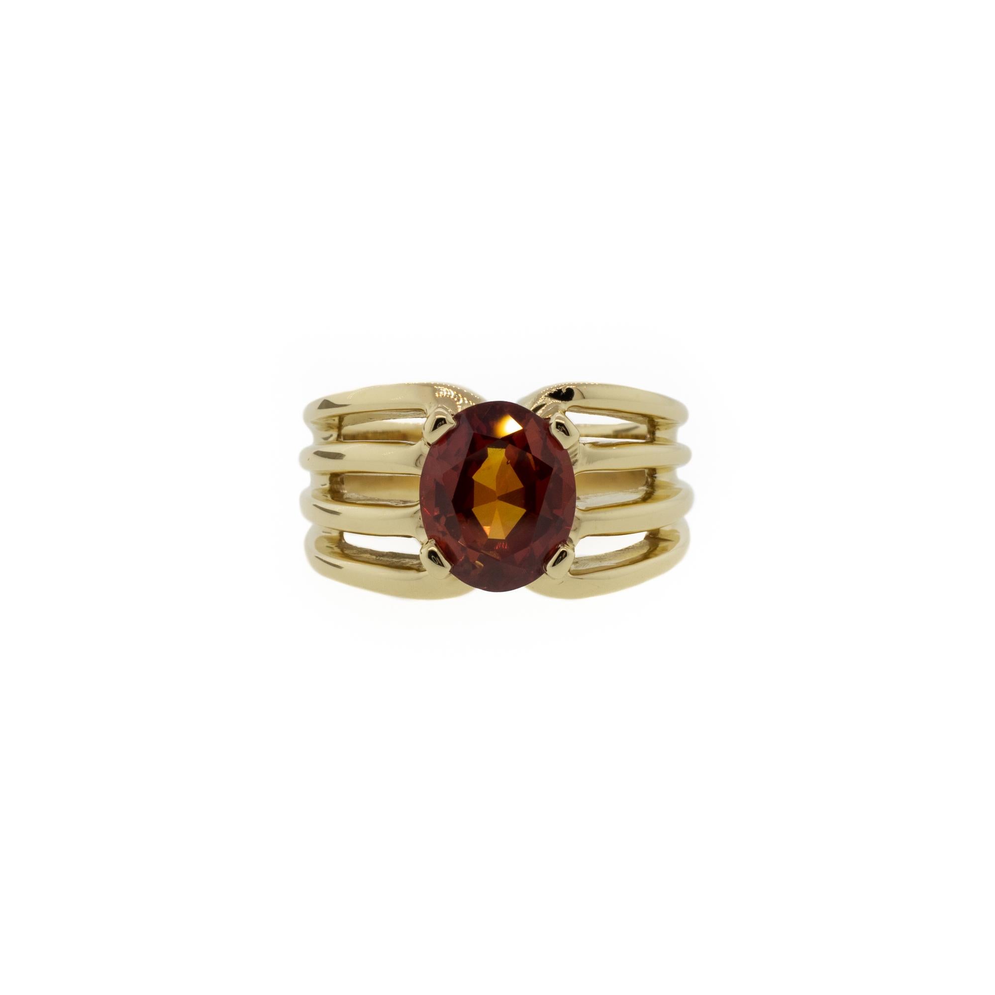 A rare natural UNTREATED burnt orange color sapphire and a uniquely beautiful setting makes this a wonderful one-of-a-kind ring. The 3.22ct natural sapphire is cut in an oval shape. Set in solid 14K yellow gold in a four-prong style with a unique