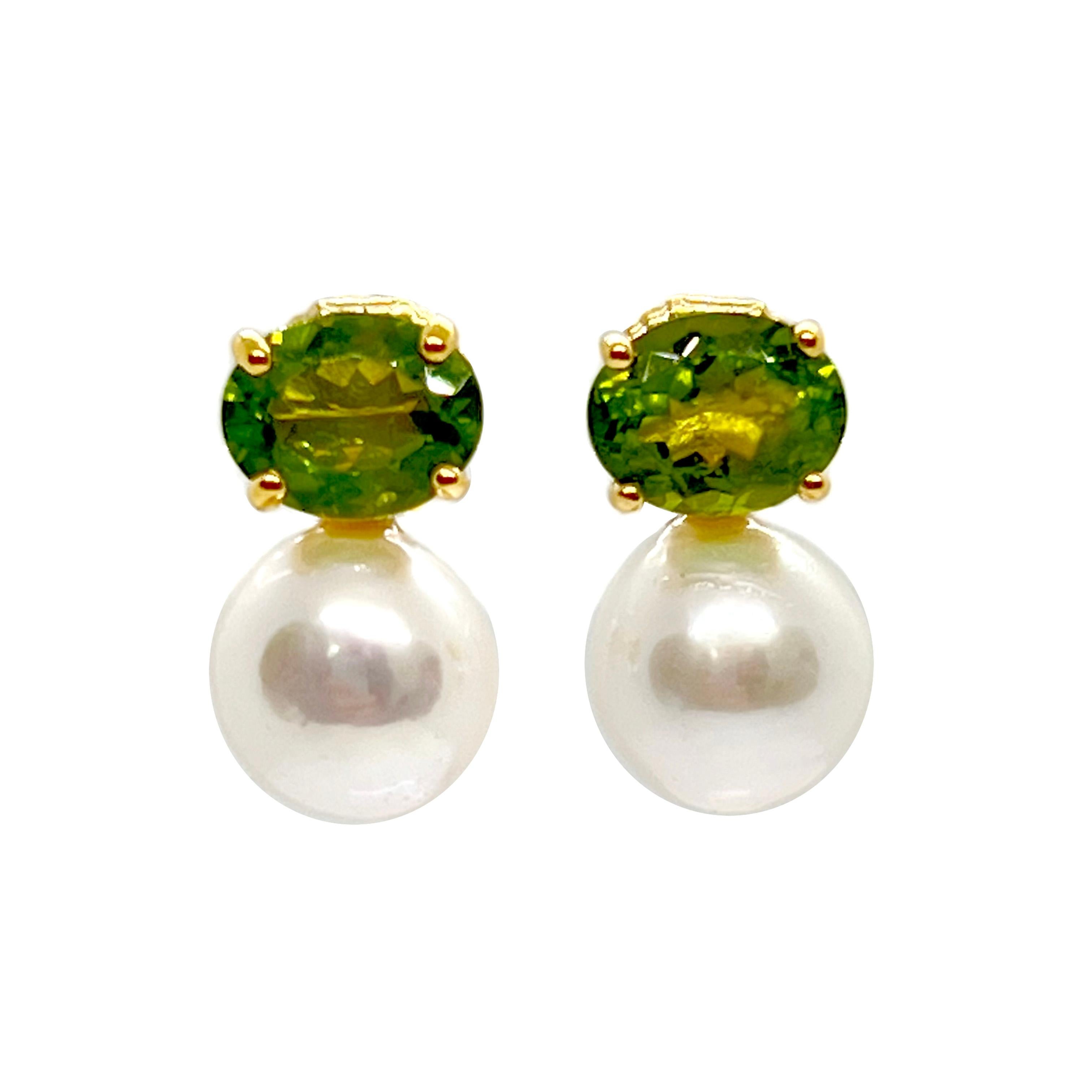Questo splendido paio di orecchini presenta una coppia di peridoto verde ovale (3ctw ciascuno) e lucenti perle d'acqua dolce coltivate bianche, incastonate in oro giallo 14k. Le perle misurano 12 mm di larghezza e 13 mm di altezza e offrono una