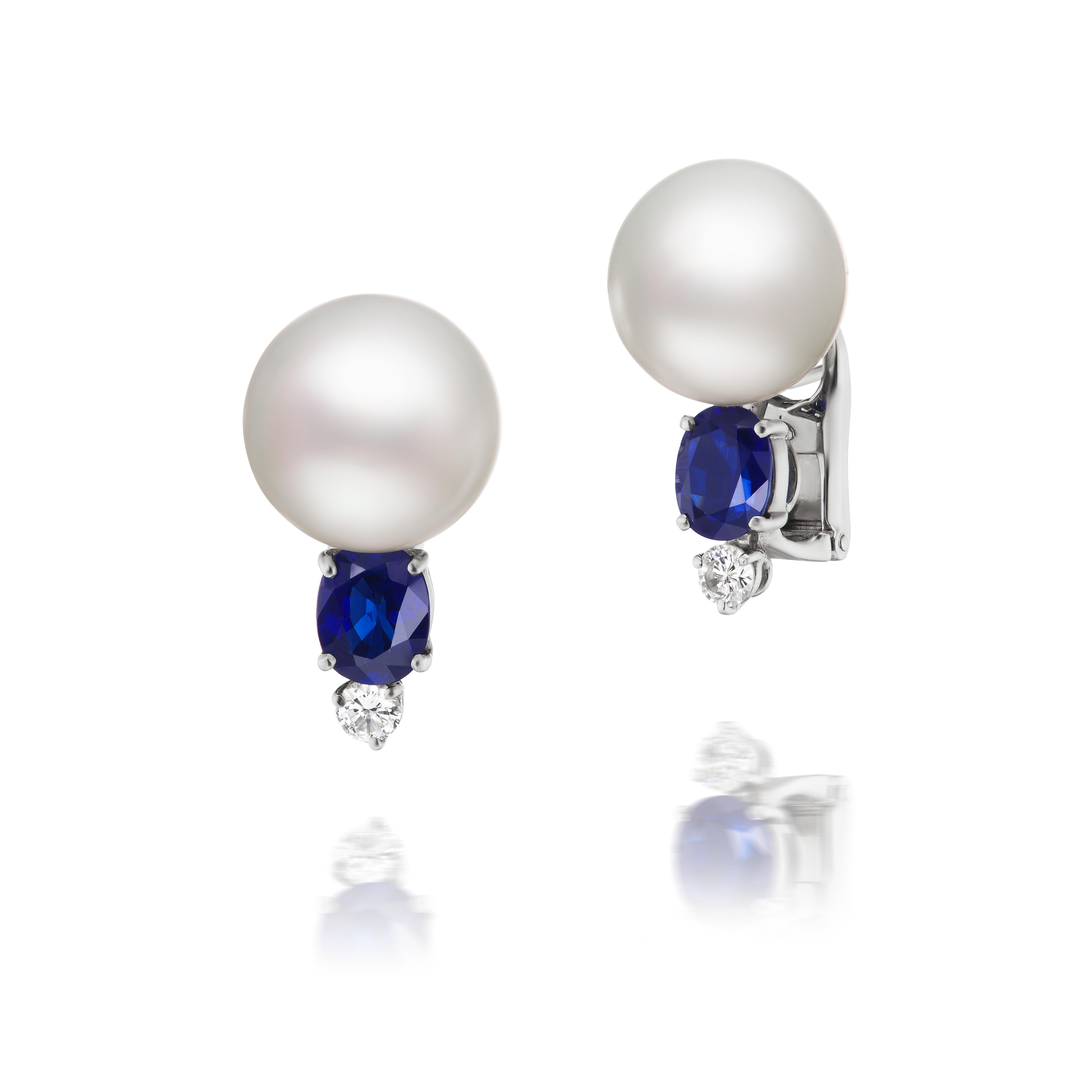 Two lovely 14mm South Sea pearls are adorned with oval-cut blue sapphires weighing approximately 1.50 carats total and round brilliant diamonds weighing approximately .30 carats total and mounted in platinum.

The sapphires are a wonderful deep blue