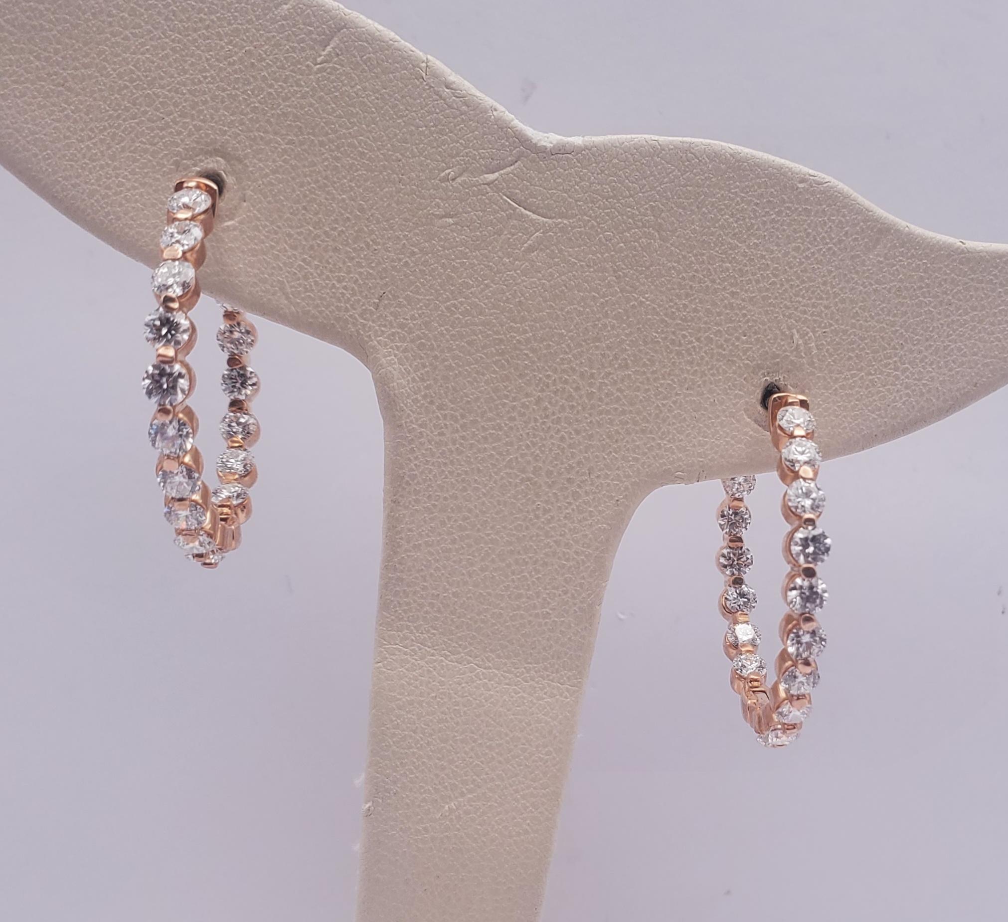 Stunning 2.89ct natural round diamond in & out single shared prong hoop earrings. These gorgeous earrings feature thirty-four stones set into a single shared prong, hinged and locking hoop setting. The diamonds are G-H in color and SI in clarity.