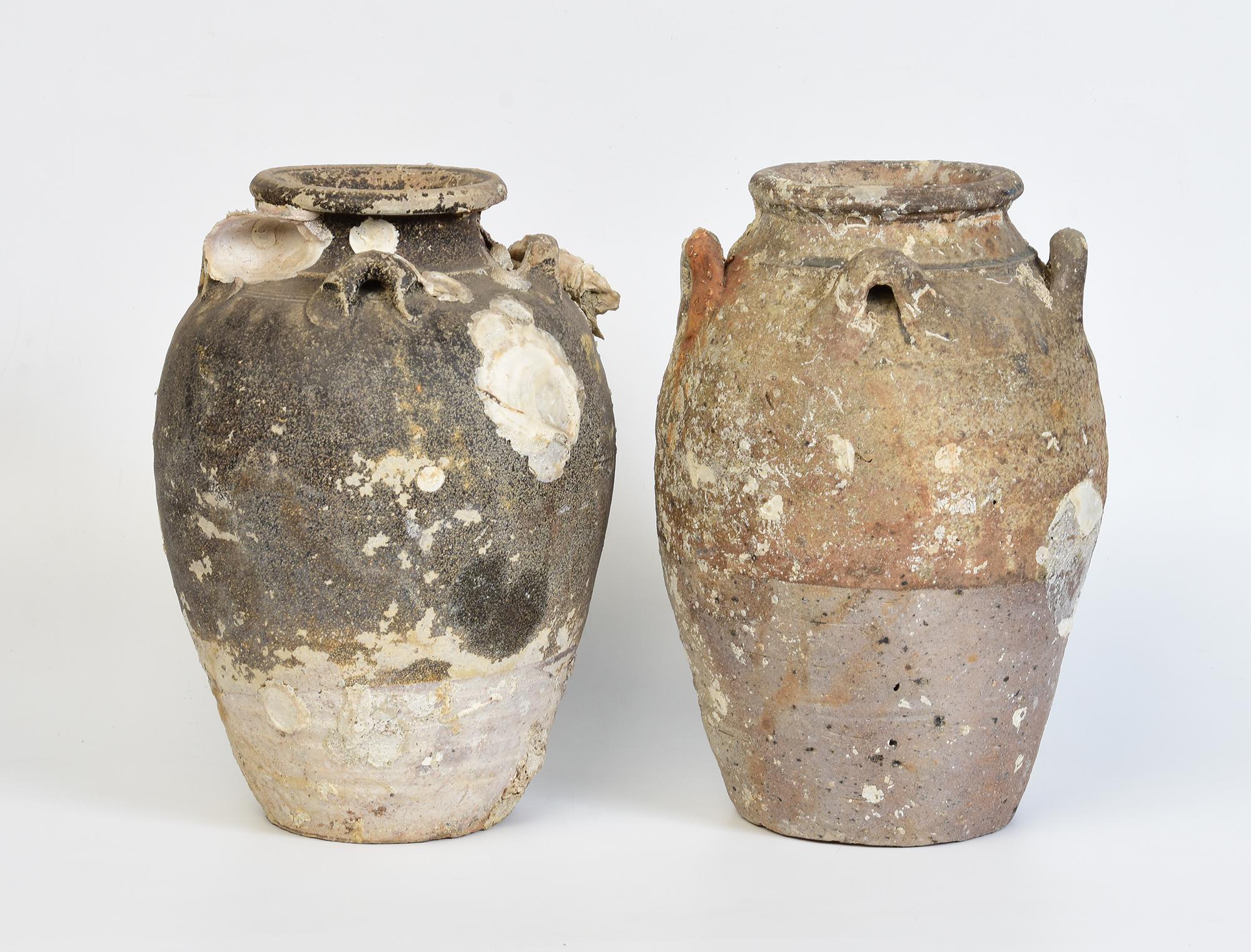 A pair of antique Sukhothai pottery jars with natural shell and barnacle from shipwreck.

Age: Thailand, Sukhothai Period, 14th - 16th Century
Size: Height 26.5 - 26.9 C.M. / Width 19 - 19.2 C.M.
Condition: Nice condition overall (some expected
