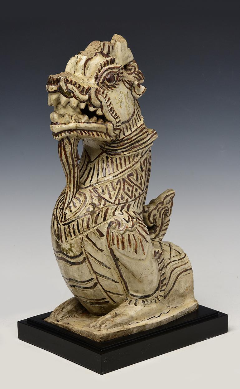 Antique Sukhothai stoneware Naga.

Age: Thailand, Sukhothai Period, 14th - 16th Century
Size of Naga only: Height 38.5 cm. / width 16.3 cm. / length 19 cm.
Size including stand: Height 41.5 cm. / width 18 cm. / length 23 cm.
Condition: Nice